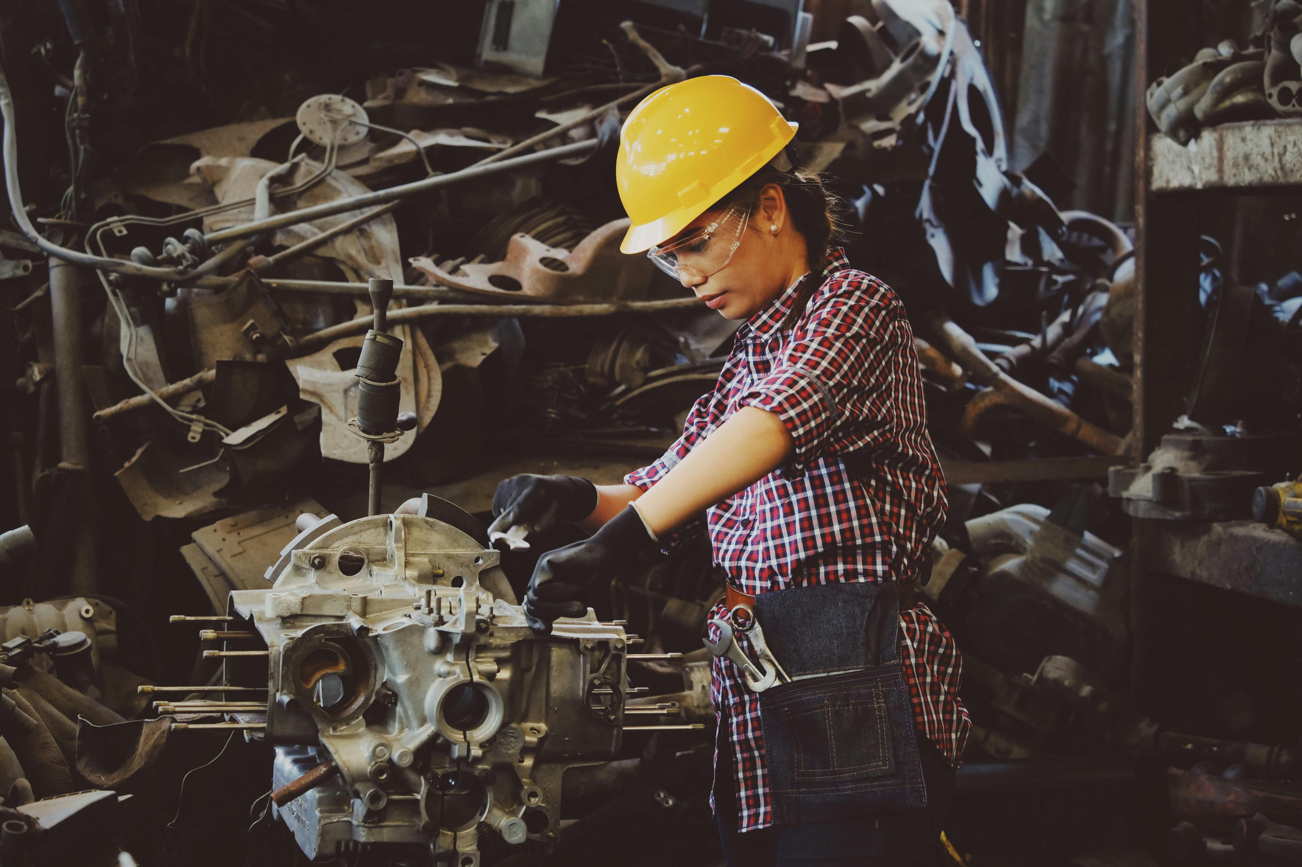 Woman working on a vehicle part | Source: Pexels