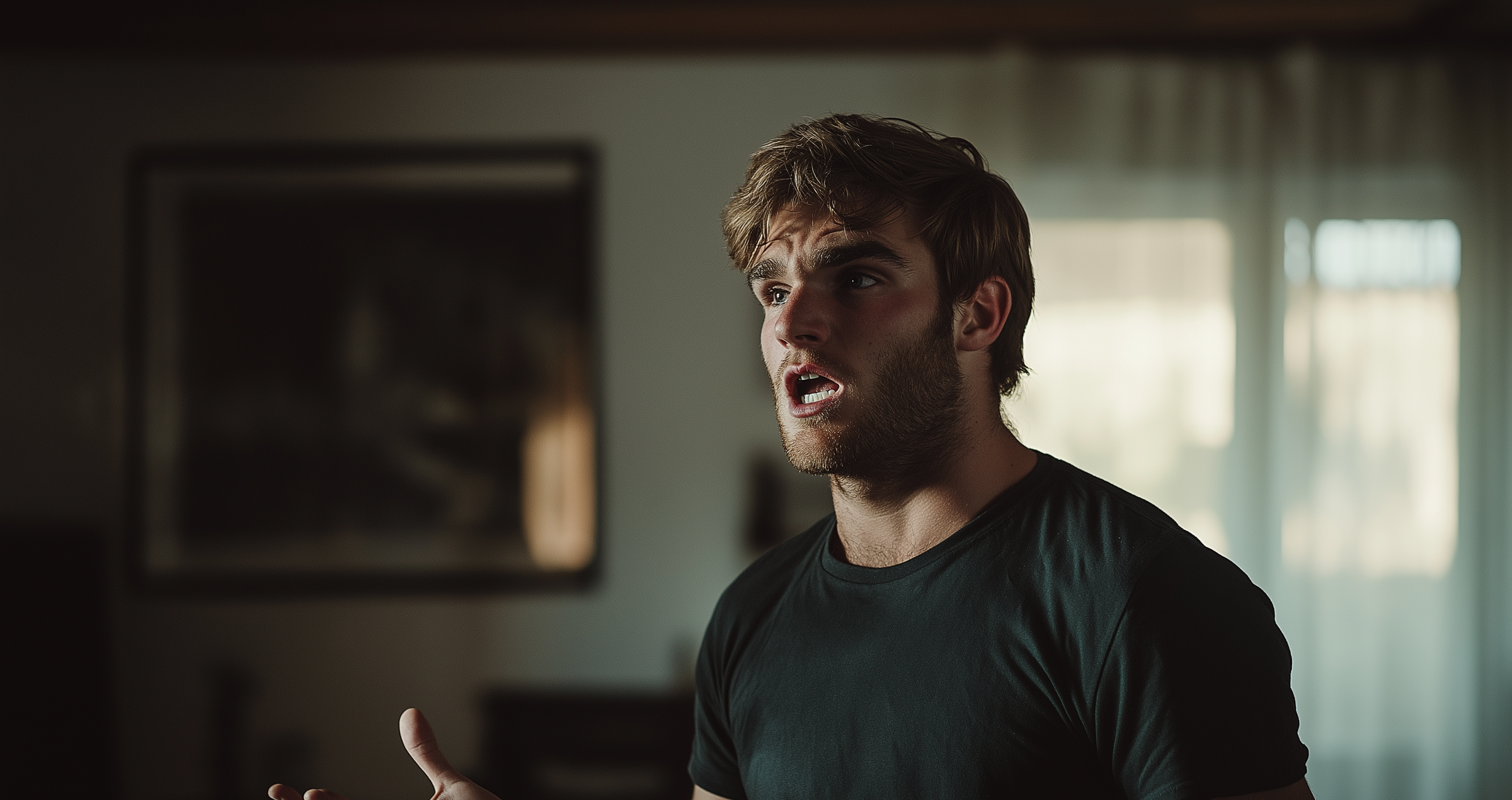 A man in a living room with his mouth open, begging | Source: no source