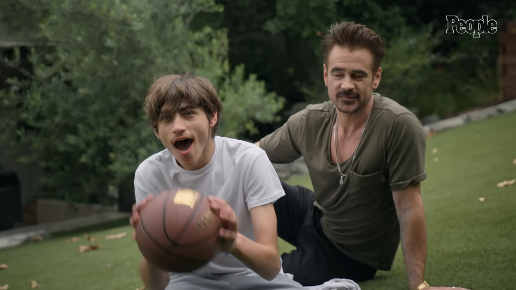 Colin Farrell looks as his son James holds a basketball, from a post dated August 7, 2024. | Source: YouTube/ People