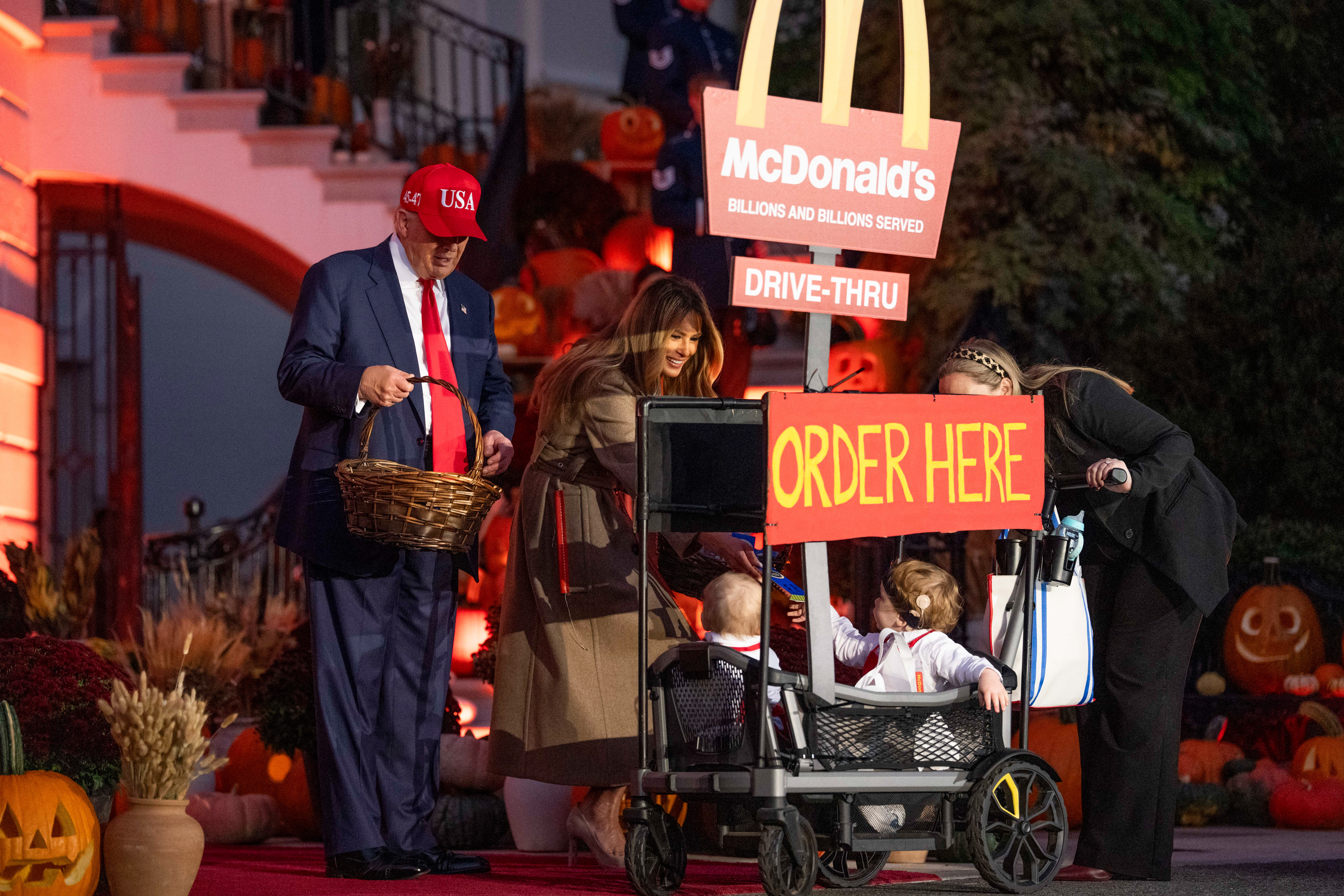 US President Donald Trump, left, and First Lady Melania Trump greet children dressed up in costume during a Halloween event on the South Lawn of the White House on October 30, 2025, in Washington, D.C. | Source: Getty Images