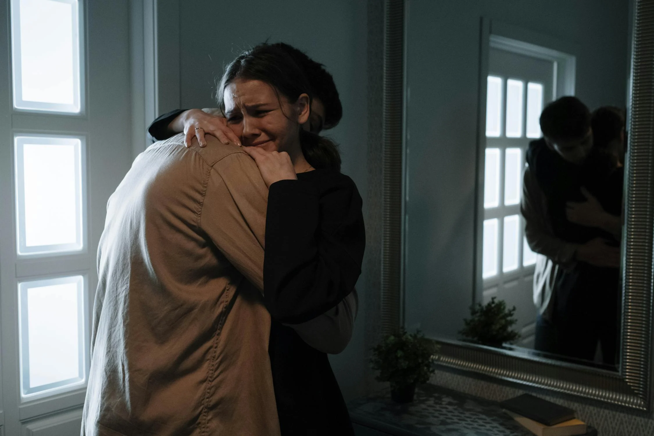 A man hugging his crying wife | Source: Pexels