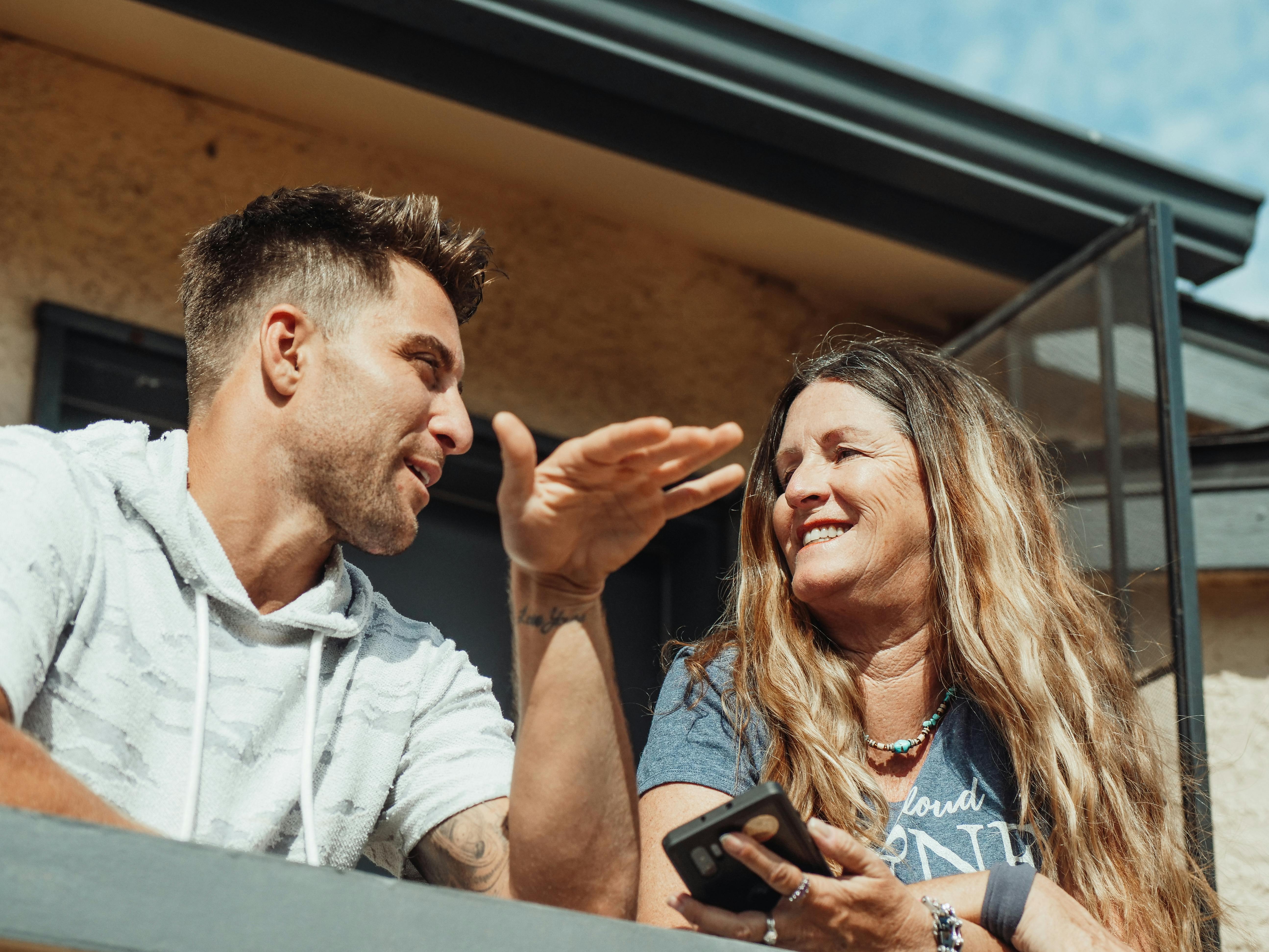 Elderly woman talking to her son on a balcony | Source: Pexels