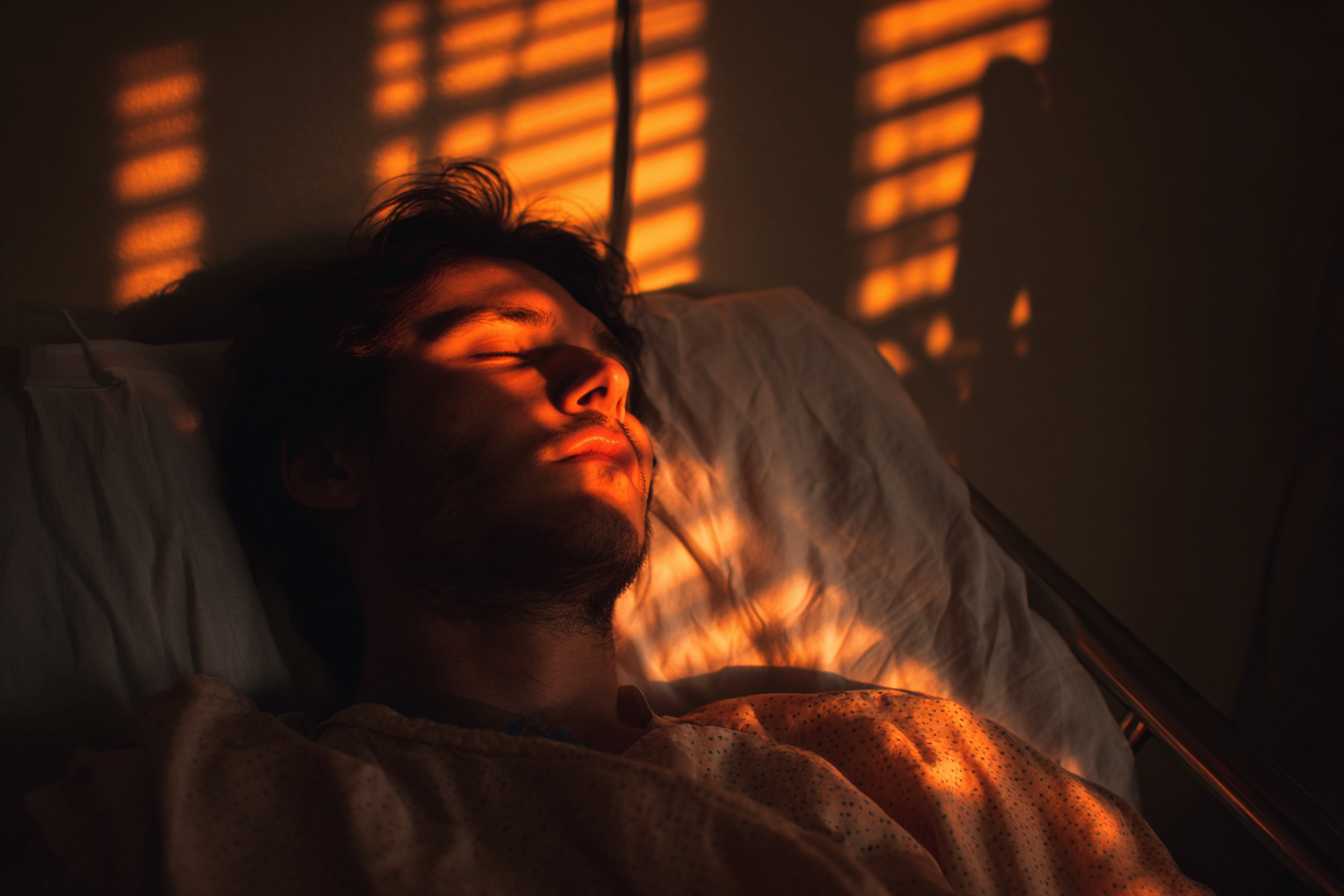 A man sleeping in a hospital bed | Source:  no source