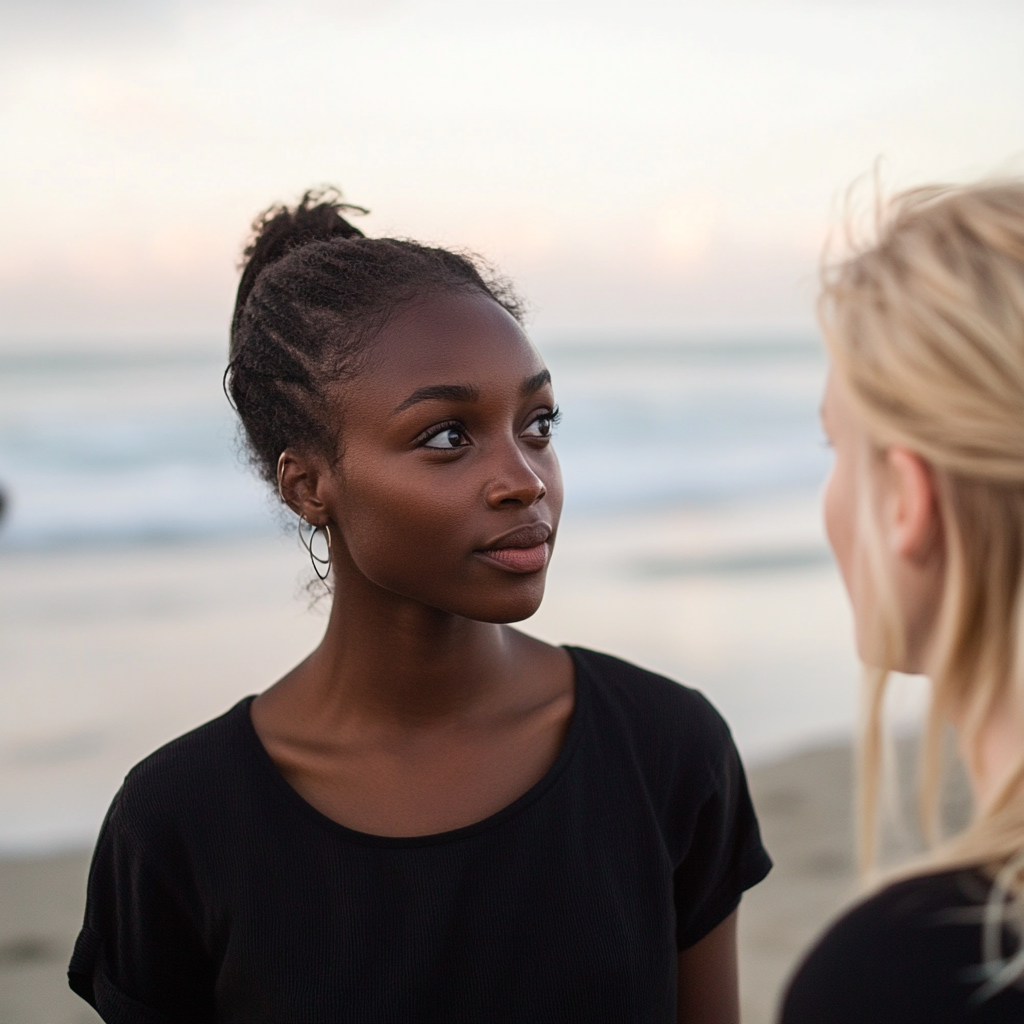 Two women talking at the beach | Source: no source