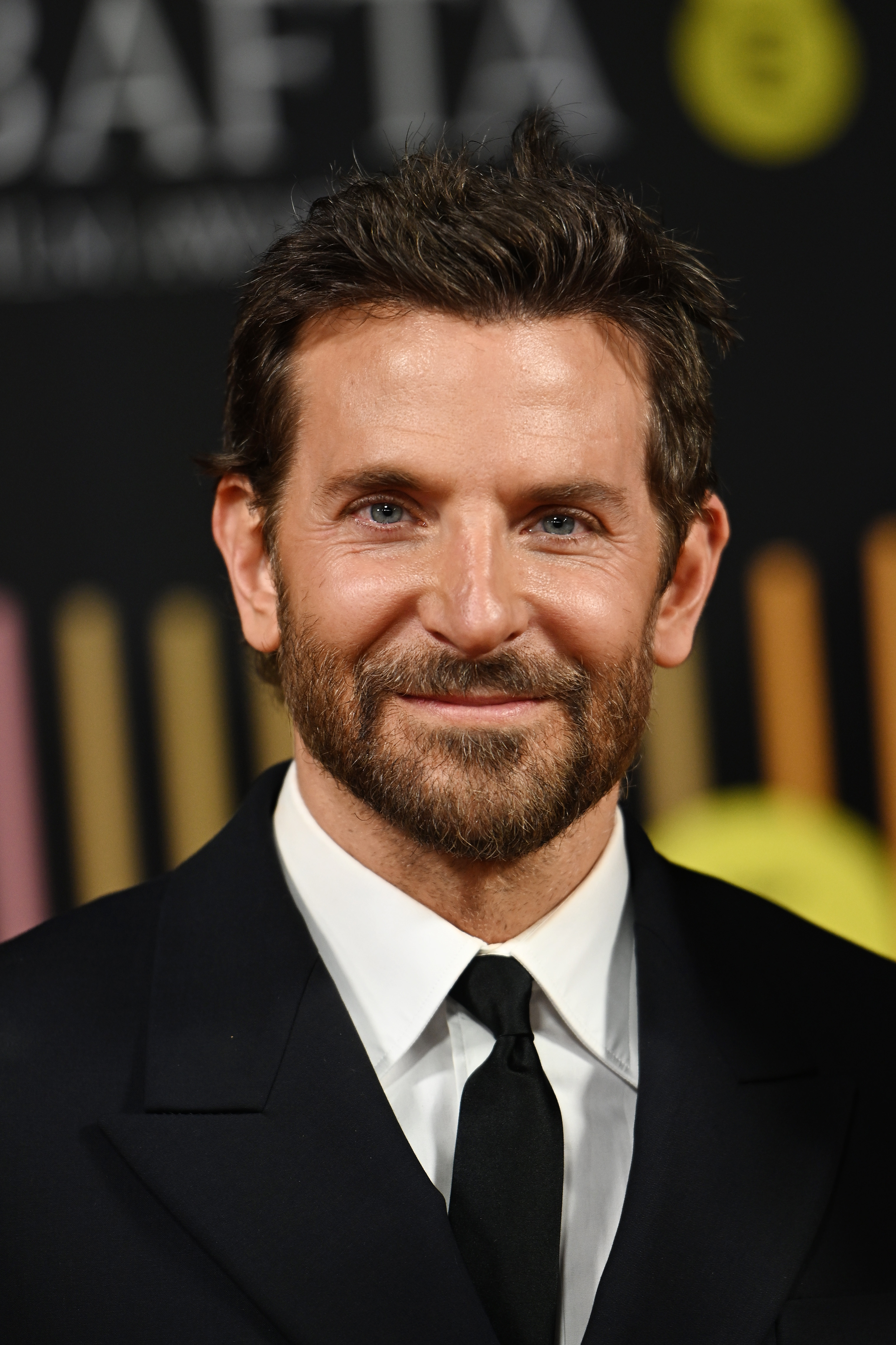 Cooper exhibited a distinguished appearance with fine lines around his eyes, a fuller dark beard with hints of gray, and short, dark brown hair styled with a slight quiff as he attended the EE BAFTA Film Awards 2024 at The Royal Festival Hall on February 18, 2024, in London, England. Although he has aged, he still looked mostly the same.