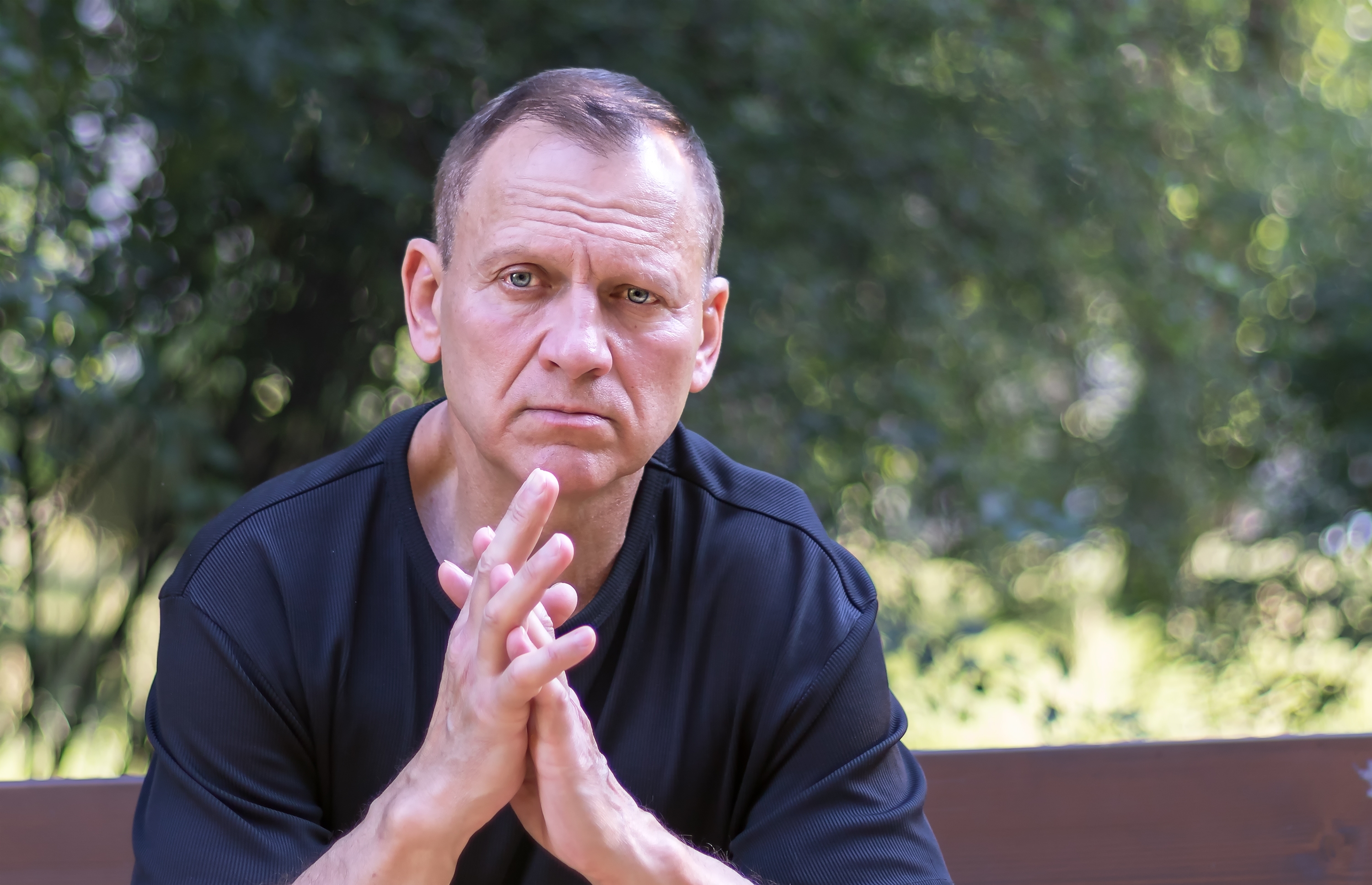 Serious man is sitting on the bench | Source: Shutterstock