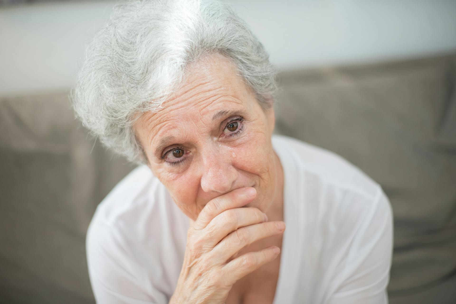 An elderly woman with tears in her eyes | Source: Pexels