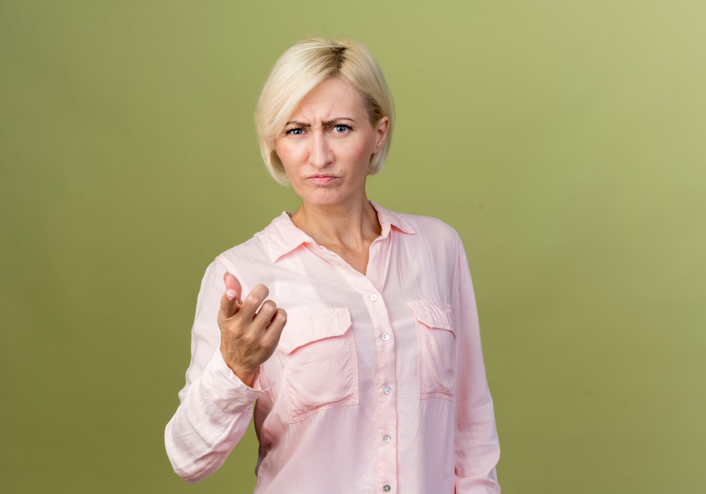 An angry mature woman pointing at the camera | Source: Freepik