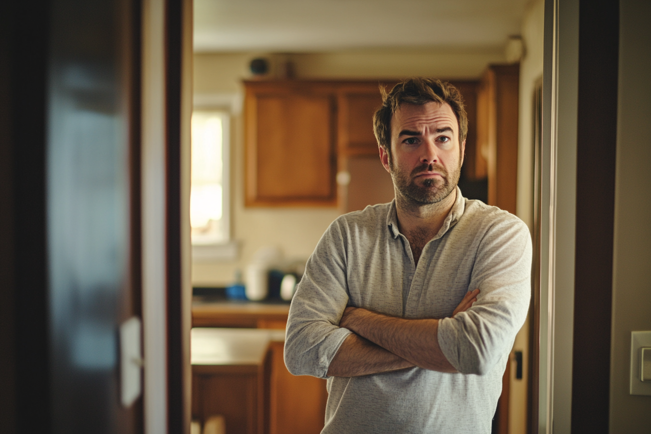 An angry man standing in a doorway | Source: No source