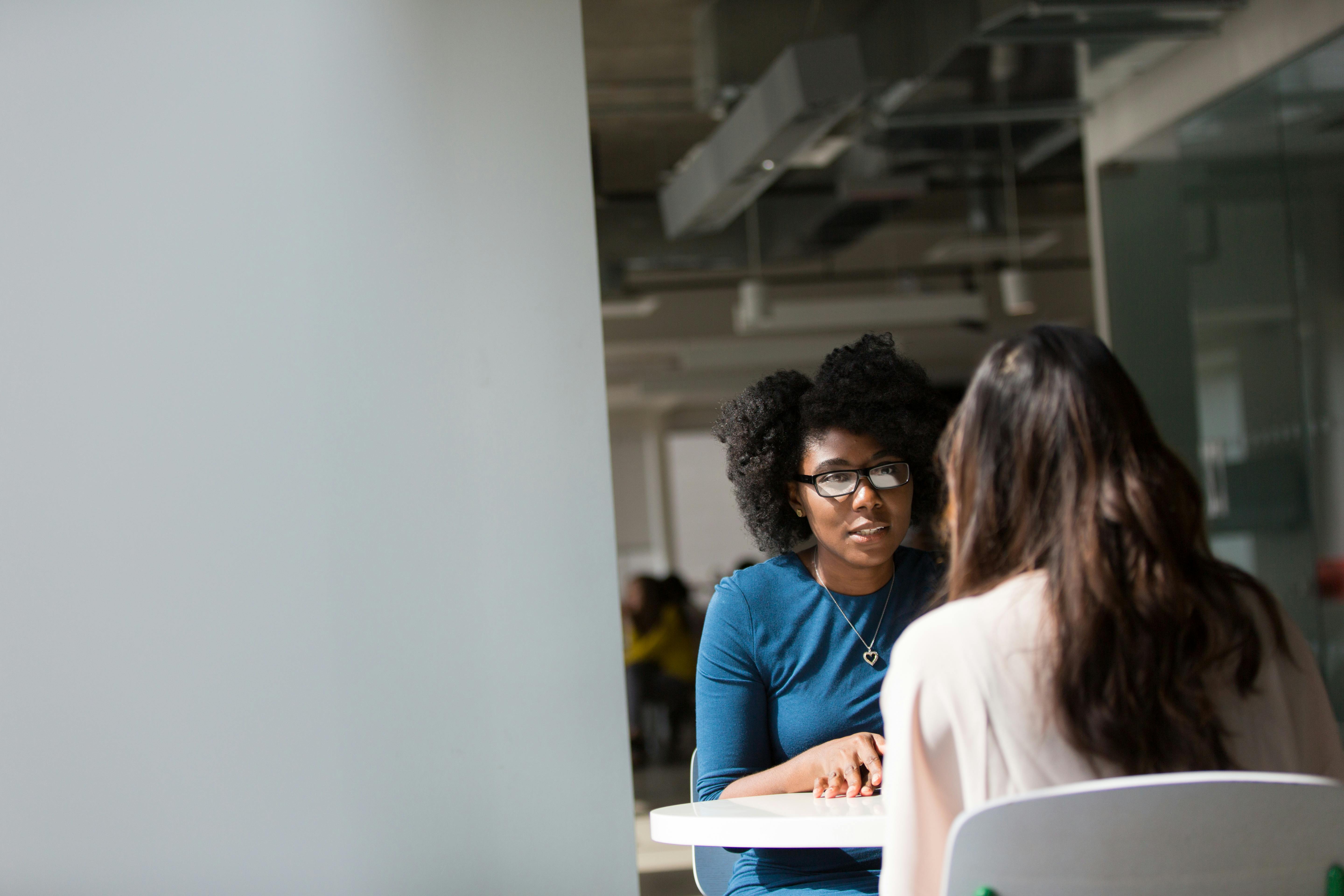 Woman wearing blue top next to table | Source: Pexels