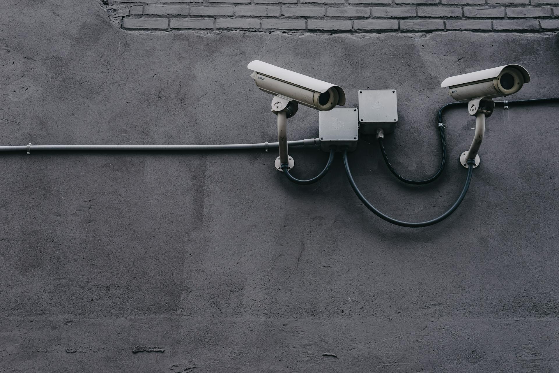 Security cameras mounted on a wall | Source: Pexels