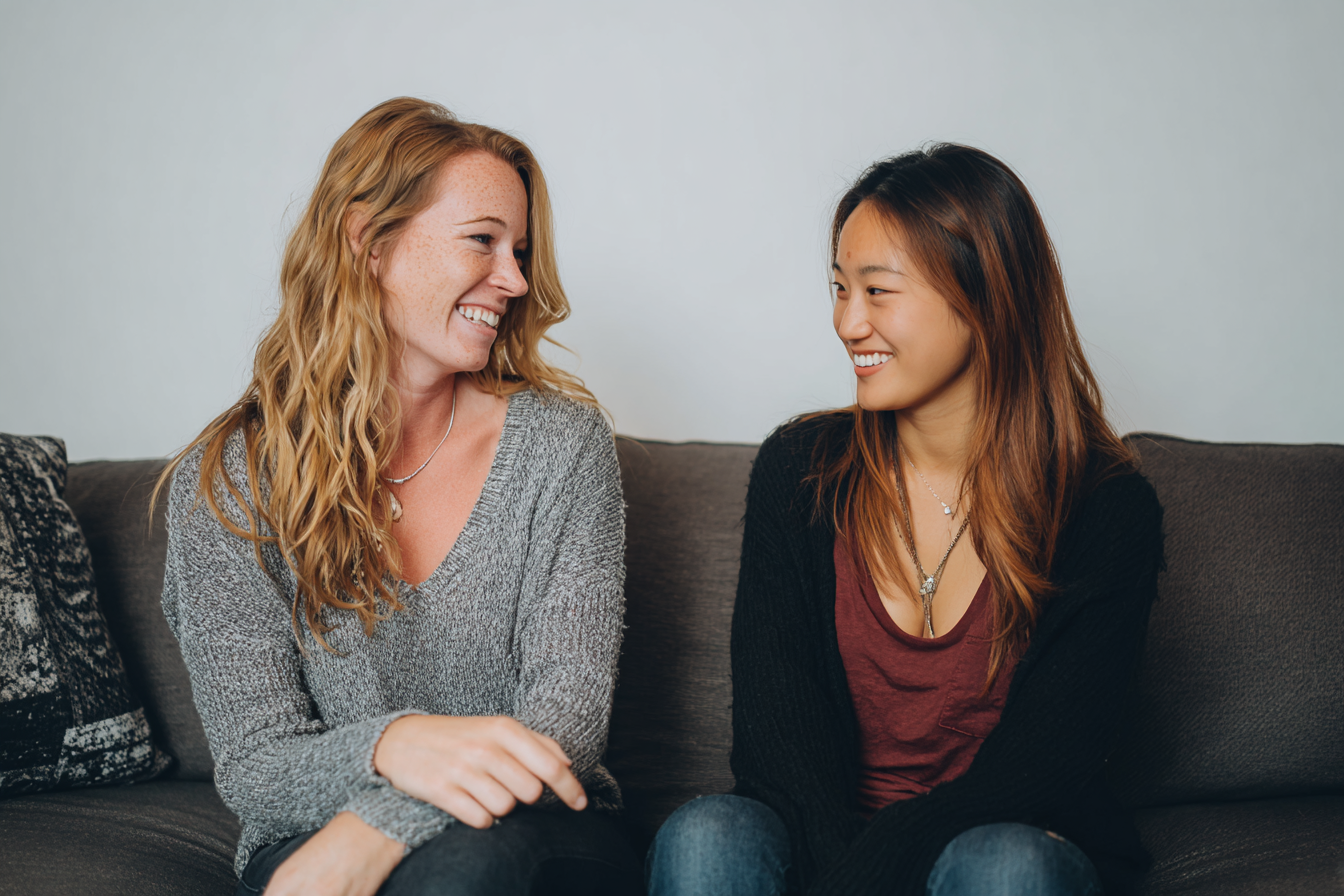 Two women smiling at each other | Source: no source