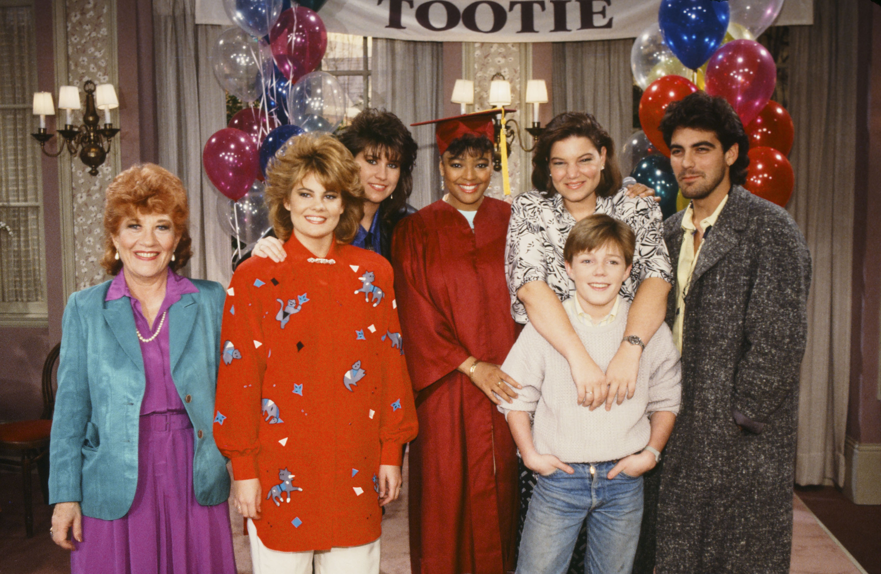 Charlotte Rae, Lisa Whelchel, Nancy McKeon, Kim Fields, Mindy Cohn, Mackenzie Astin, and George Clooney pictured in 1986 | Source: Getty Images