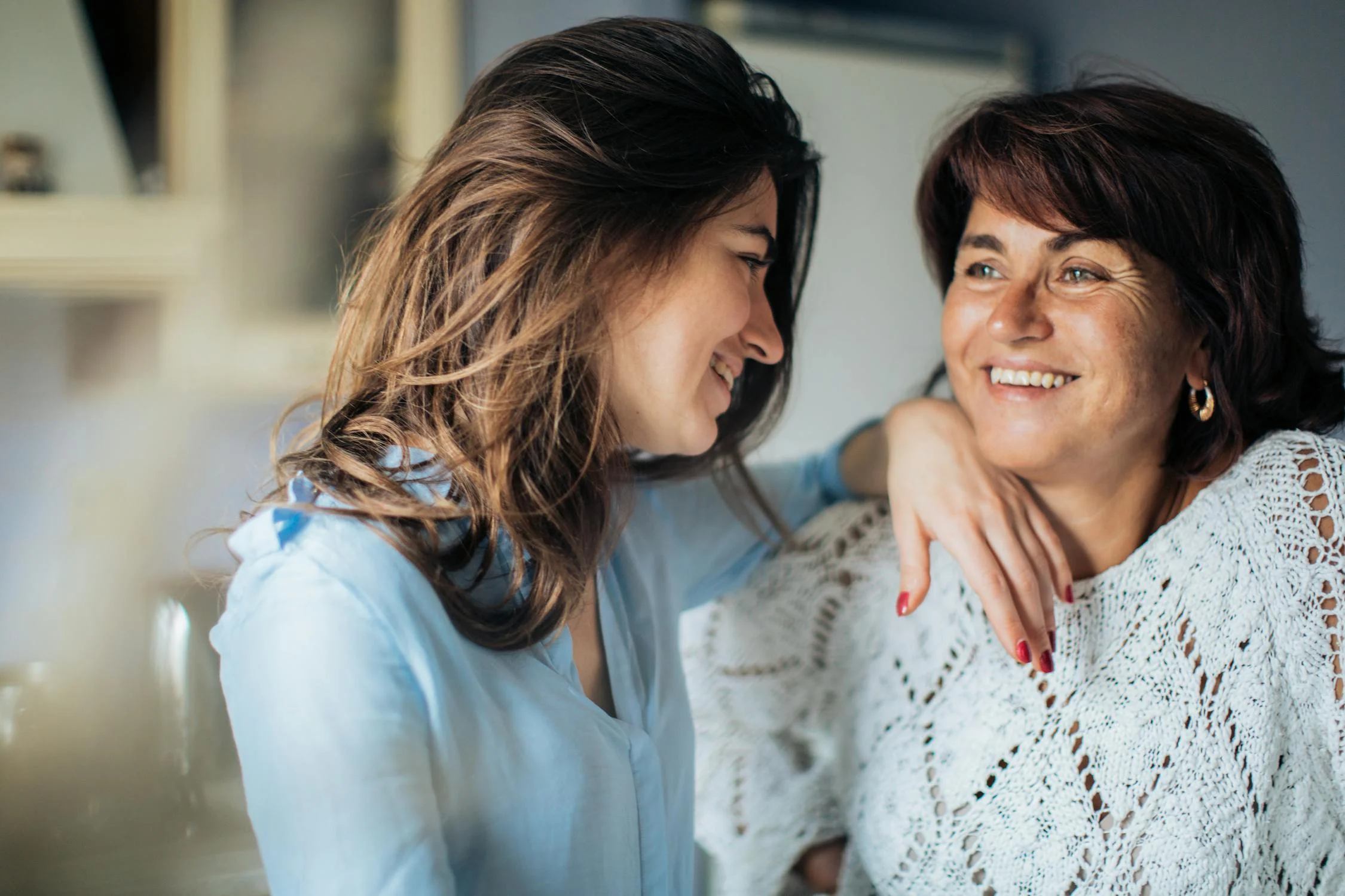 A smiling woman talking to her daughter | Source: Pexels