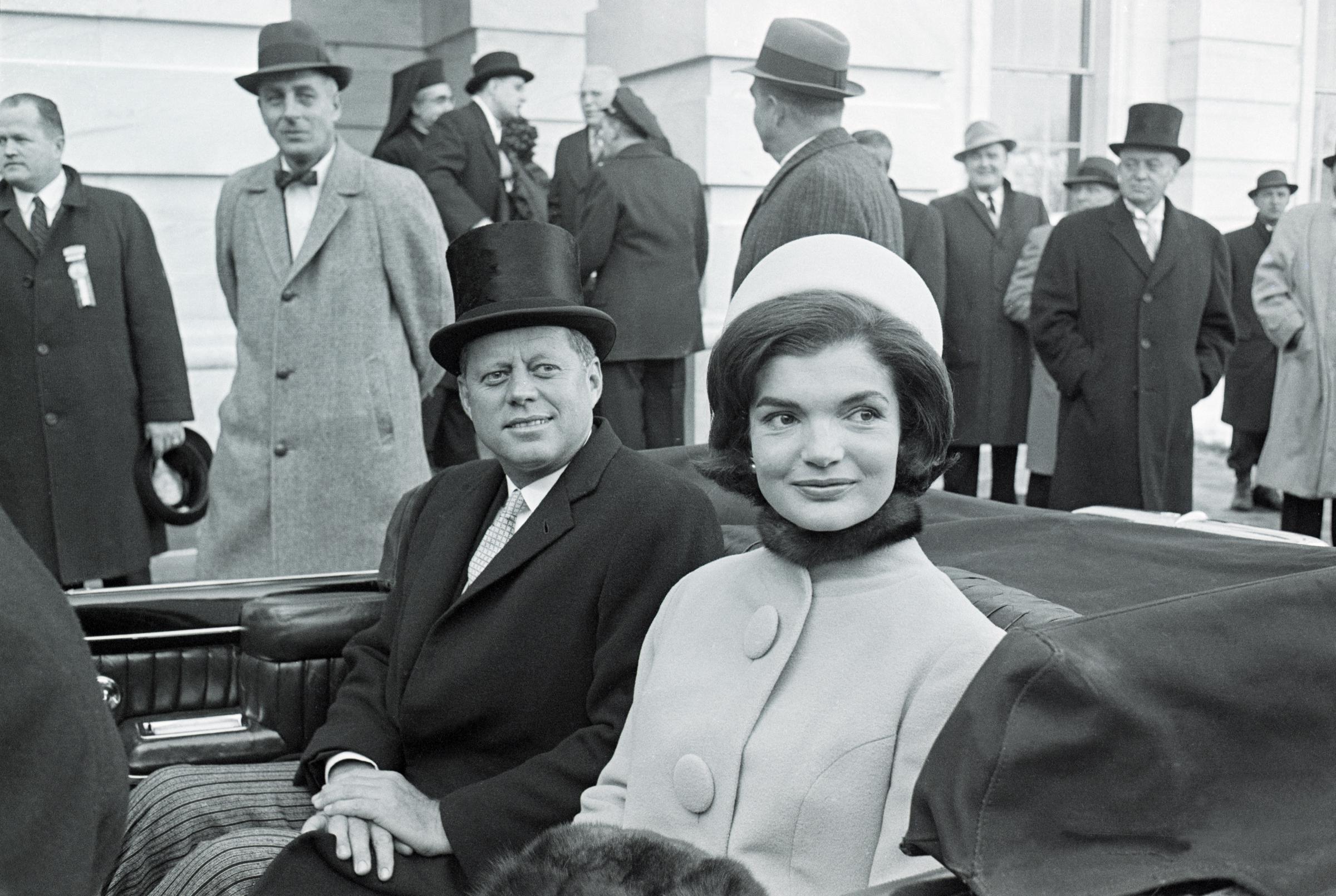 John F. Kennedy and his wife Jacqueline Kennedy Onassis depart the Capitol by car shortly after his inauguration on January 20, 1961. | Source: Getty Images