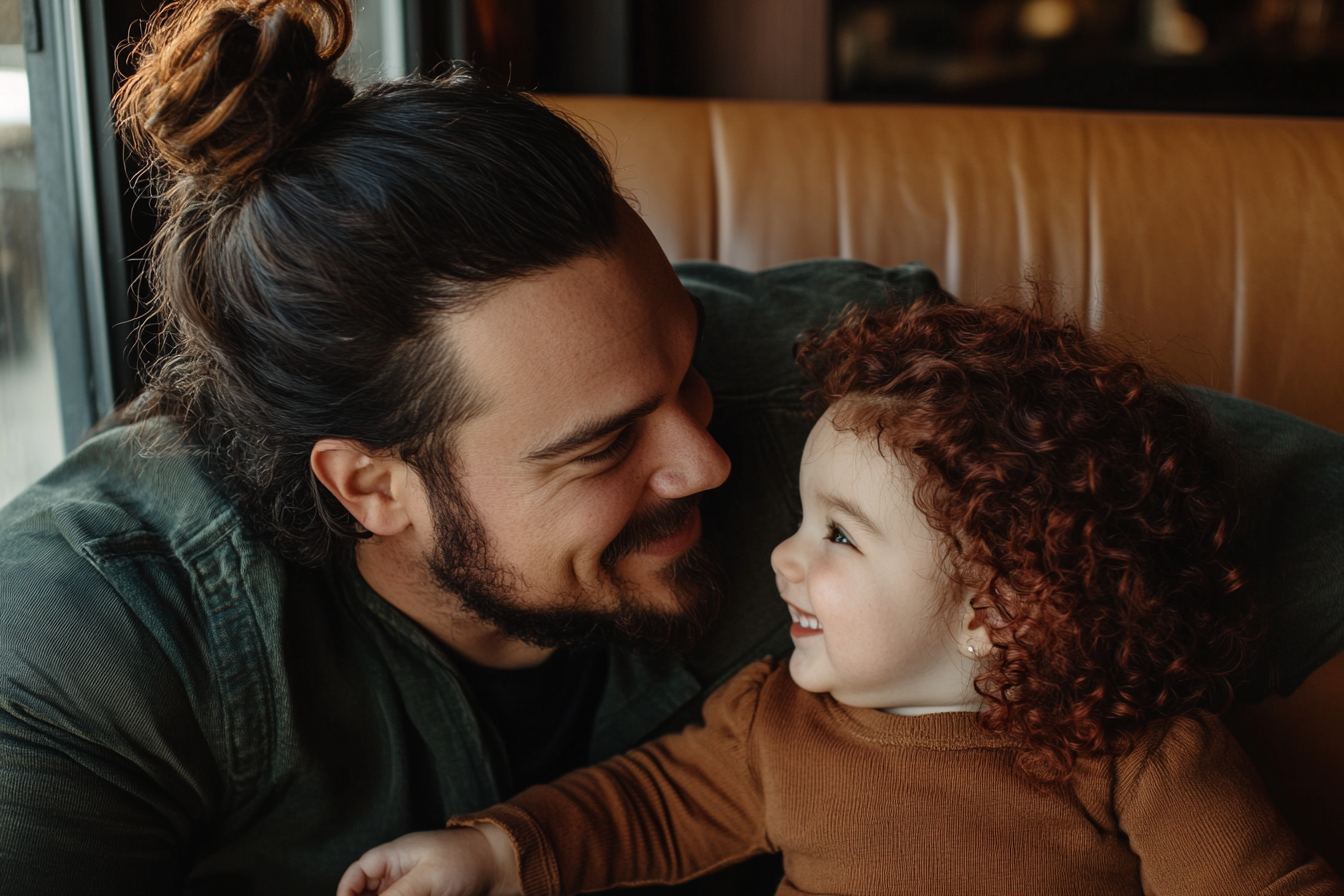 A man and a 3-year-old toddler smiling at each other | Source: no source