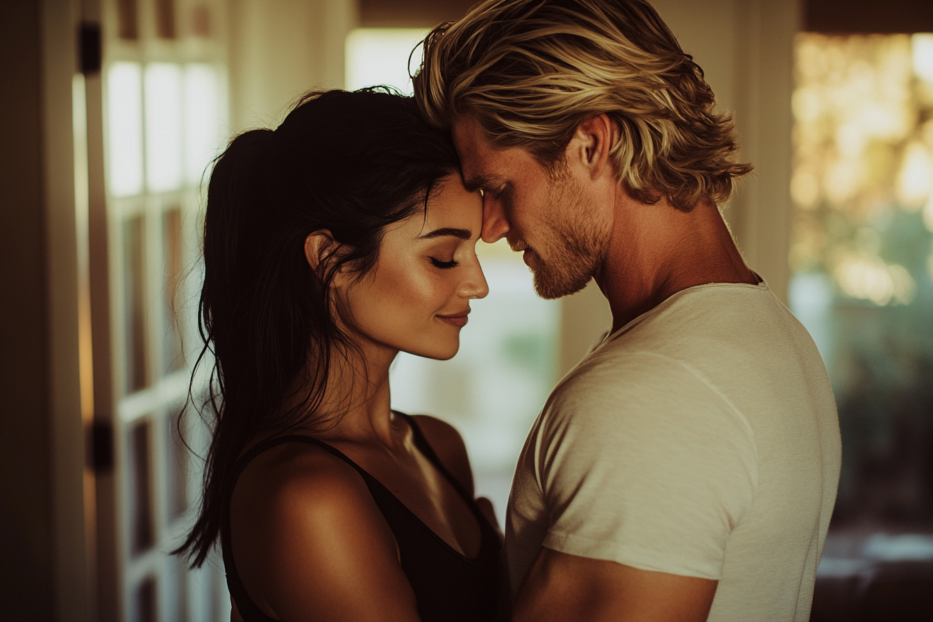 A couple in their 30s embrace in the living room, content | Source: No source