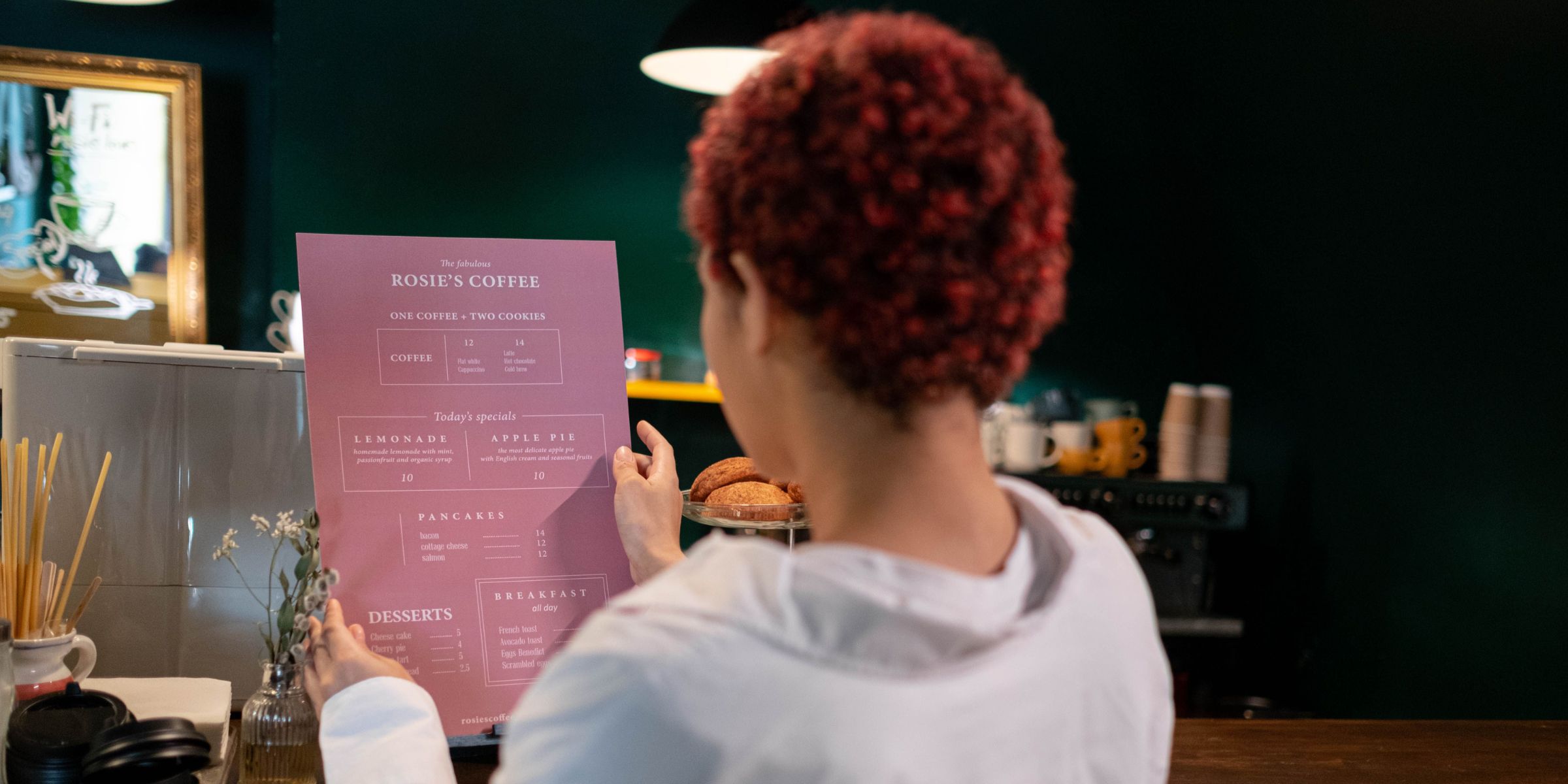 A woman browsing the menu at a café | Source: Pexels