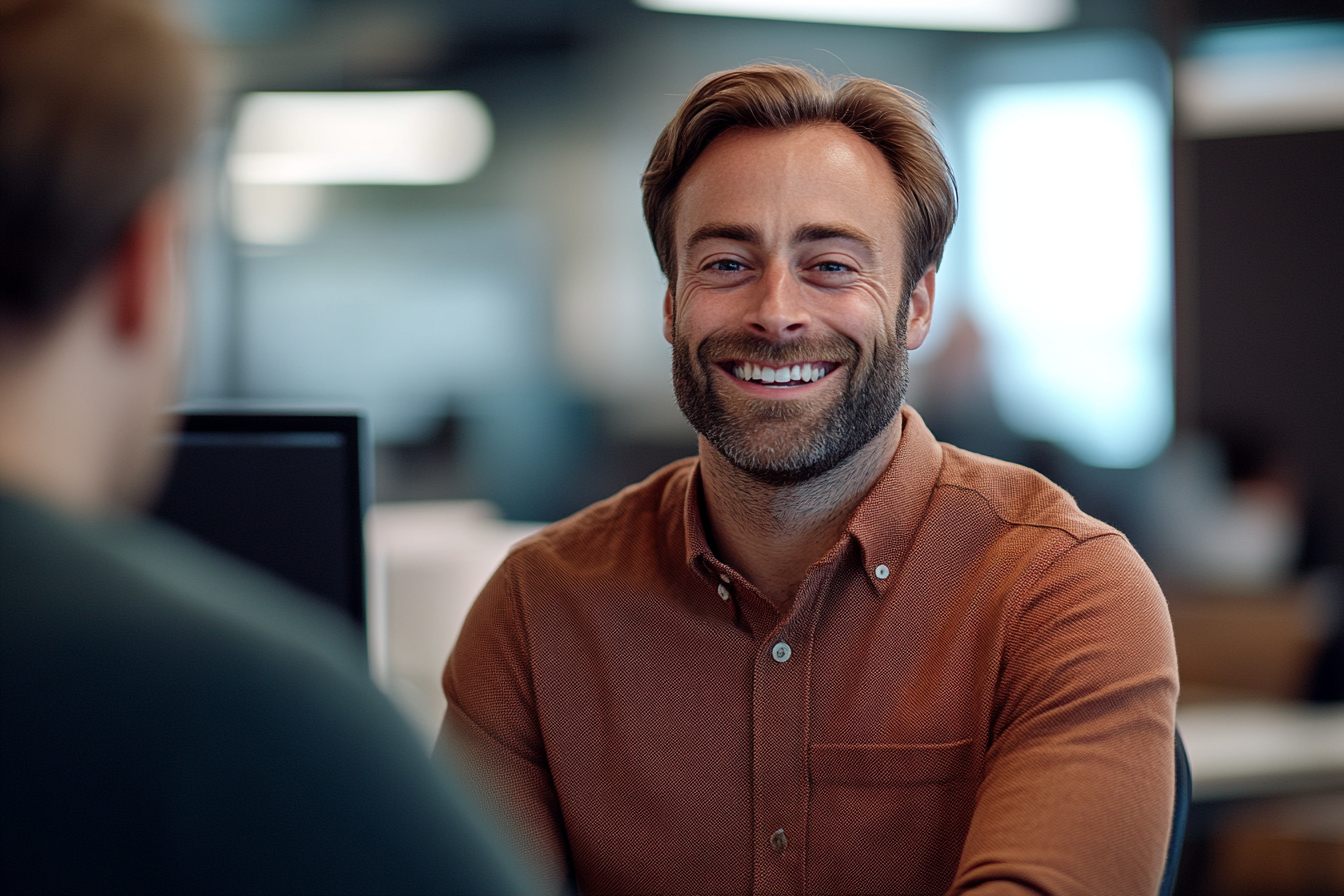 A man laughing at work | Source: No source