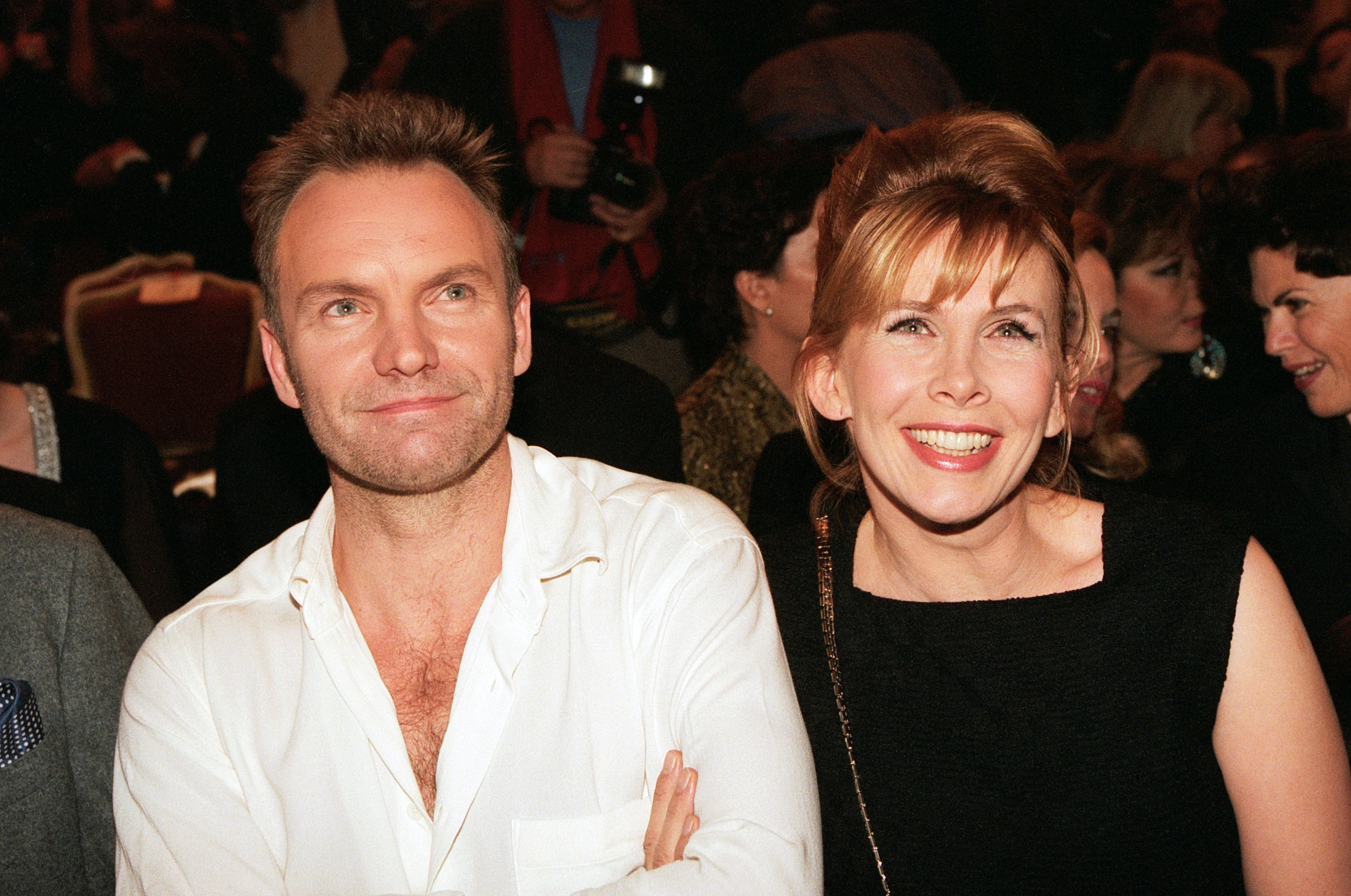 Trudie Styler wears a simple, square-neck black top or dress while attending the Versace Haute Couture Spring/Summer show with Sting as part of Paris Fashion Week on January 20, 1996, in Paris, France.