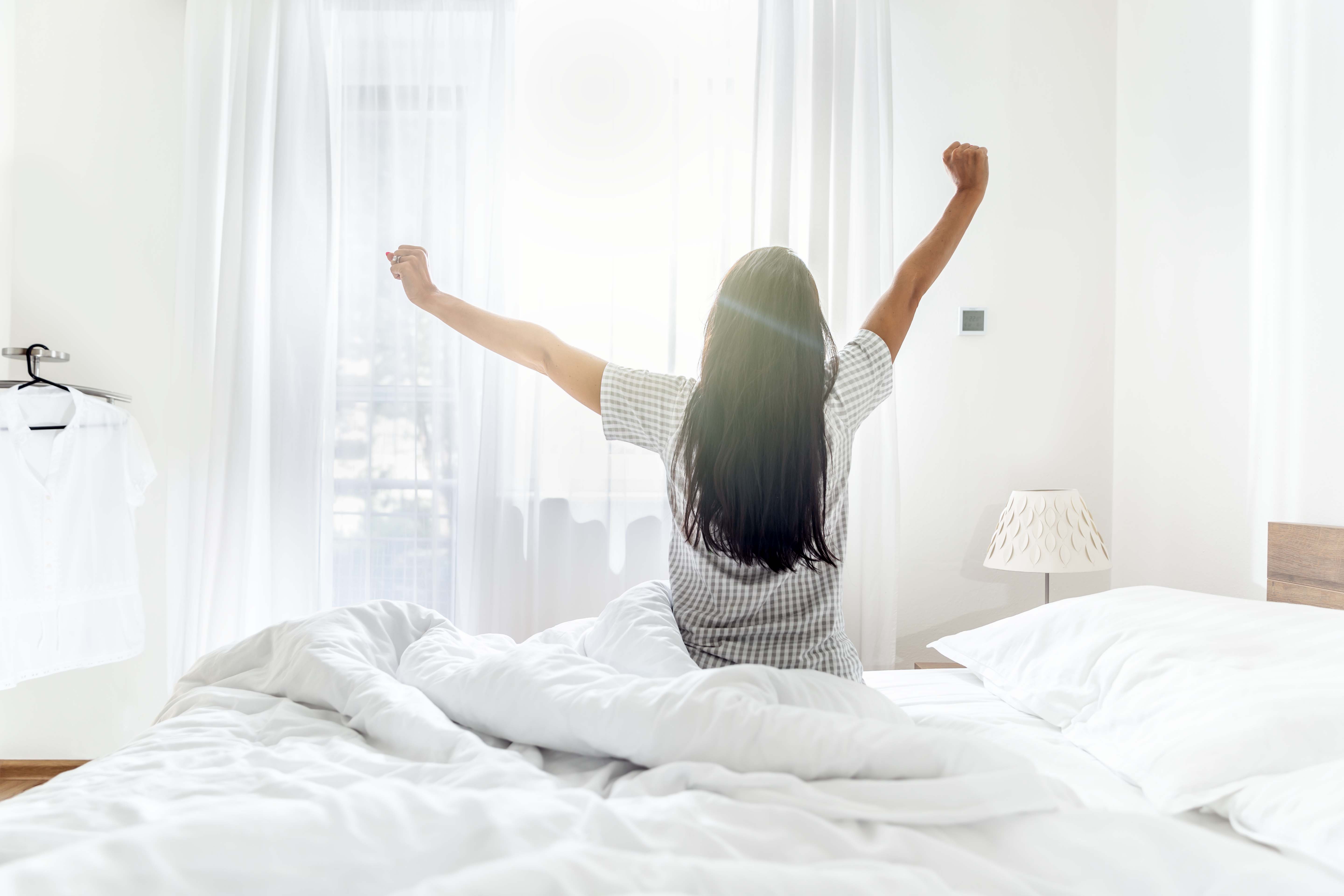 A woman waking up to a bright morning | Source: Getty Images