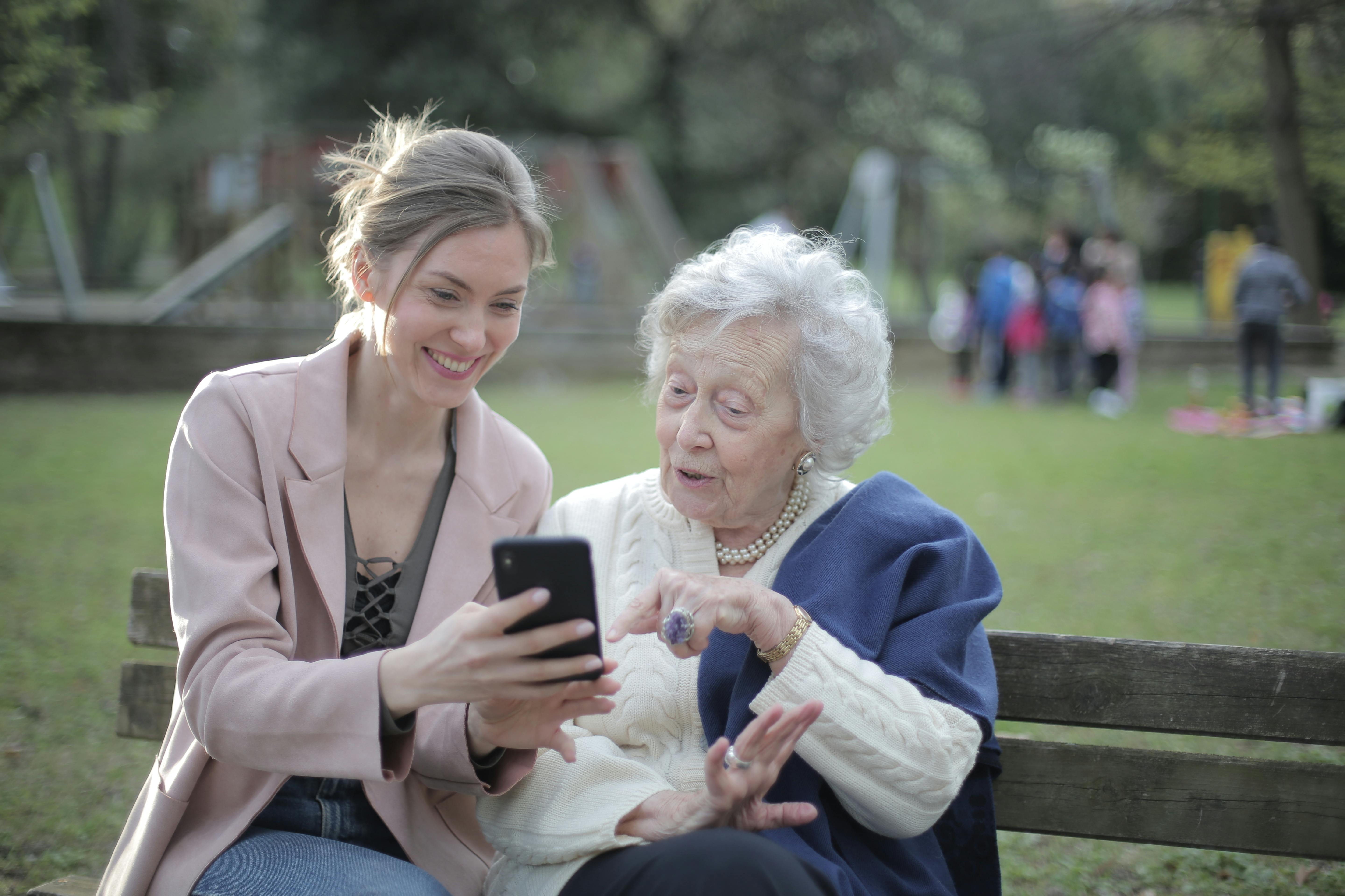 Mother and daughter using a phone | Source: Pexels