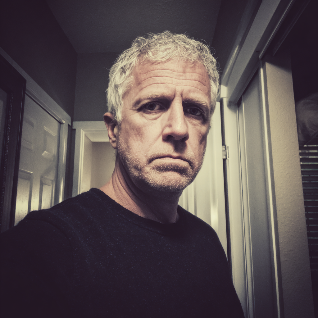 A frowning older man standing in a hallway | Source: no source