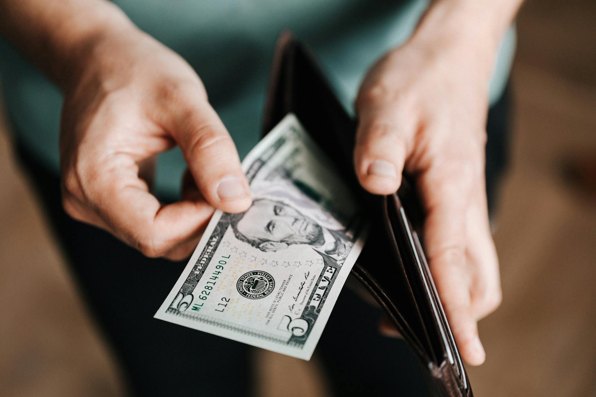 Person checking the money in his wallet | Source: Pexels