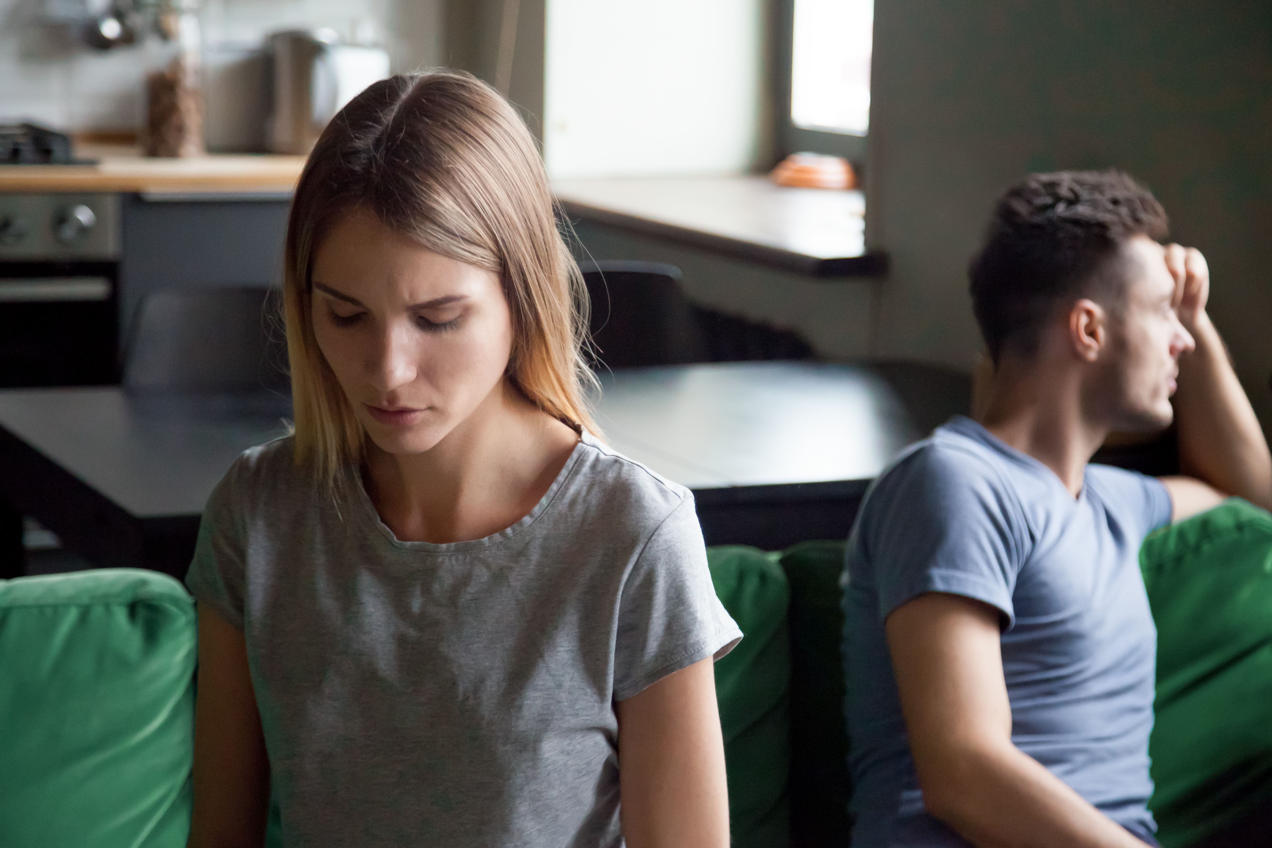 A man and a woman with their backs turned to each other | Source: Shutterstock