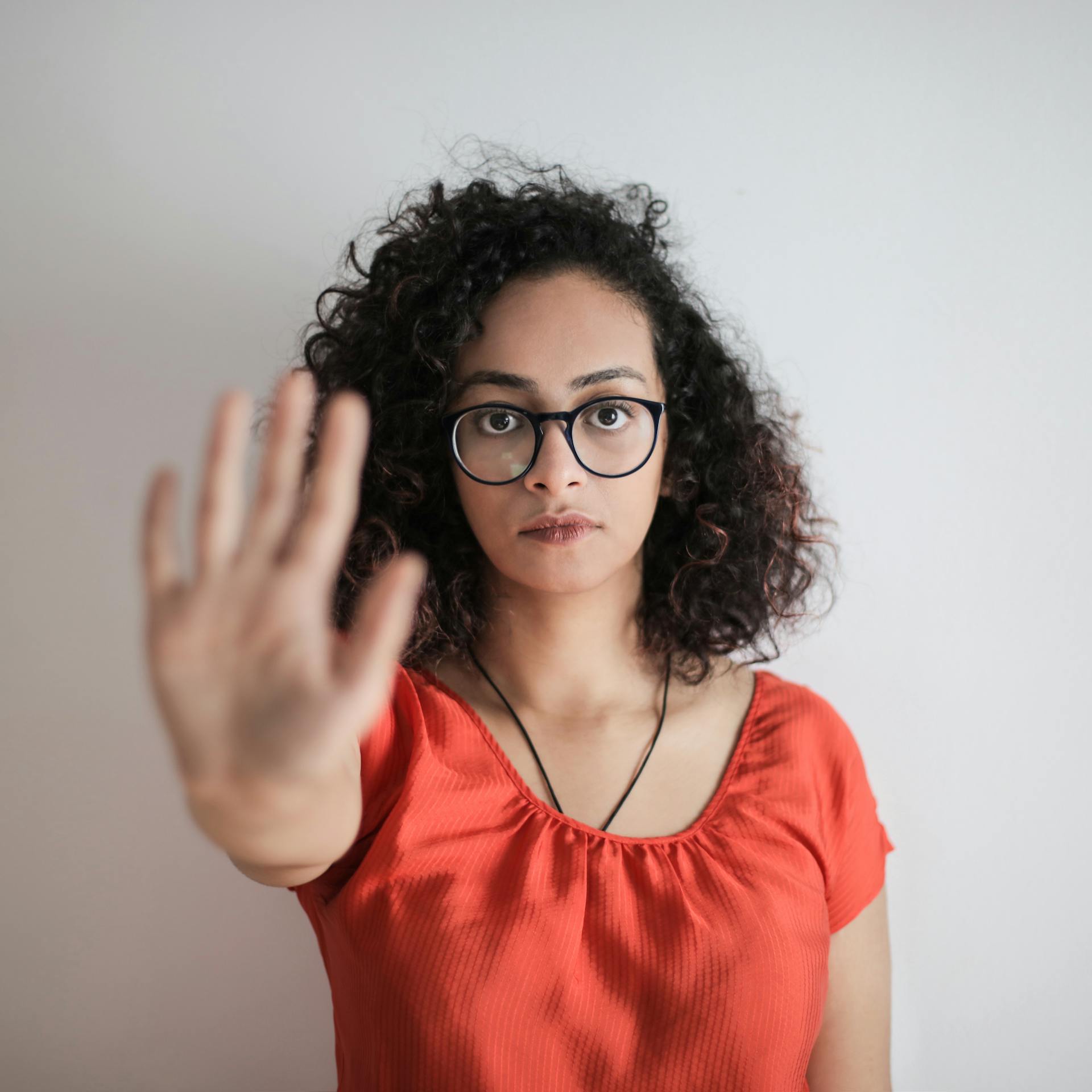 A woman holding out her hand in a 'stop' gesture | Source: Pexels