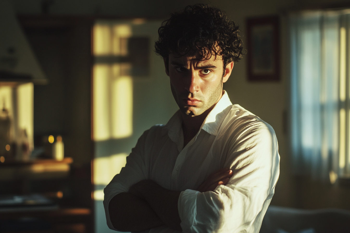 Man in his 30s with arms crossed looking disappointed in the living room | Source: No source