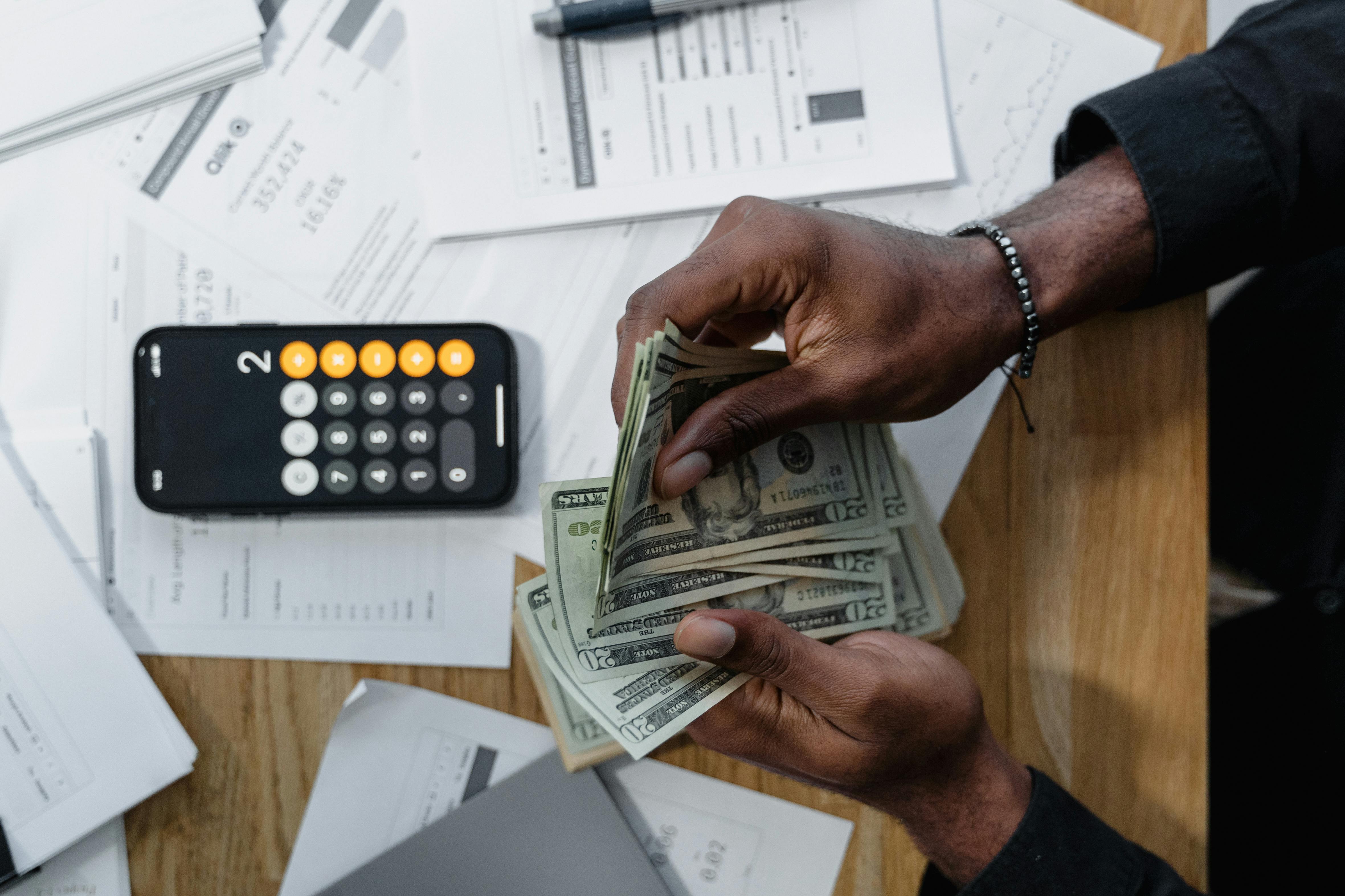 Person counting money | Source: Pexels