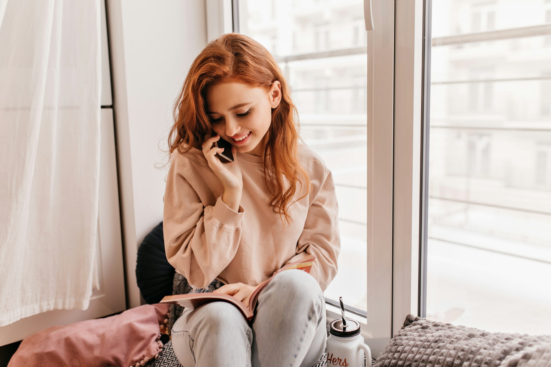 An excited woman talking on the phone | Source: Unsplash