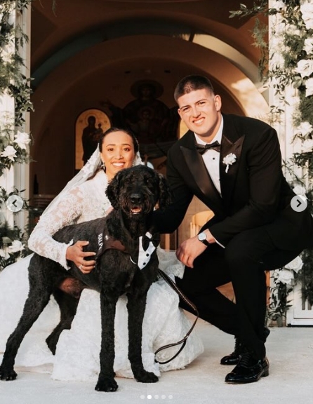 George Karlaftis and Kaia Harris posed with their dog after their wedding ceremony in a photo shared in a post dated May 11, 2026. | Source: Instagram/people