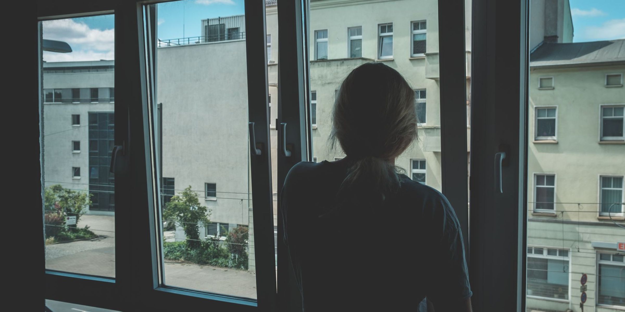 A woman staring out a window | Source: Pexels