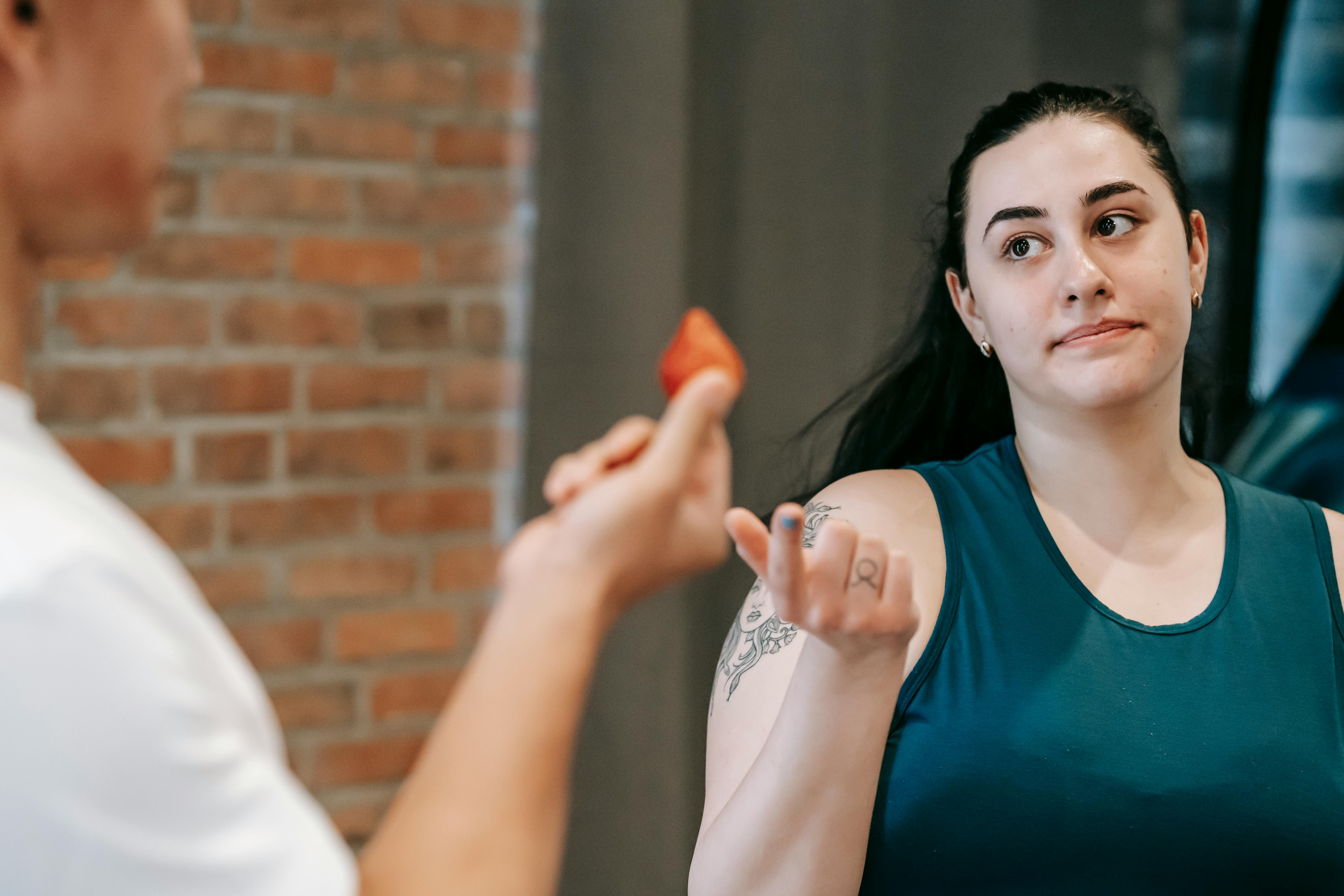 Woman looking at a fruit | Source: Pexels
