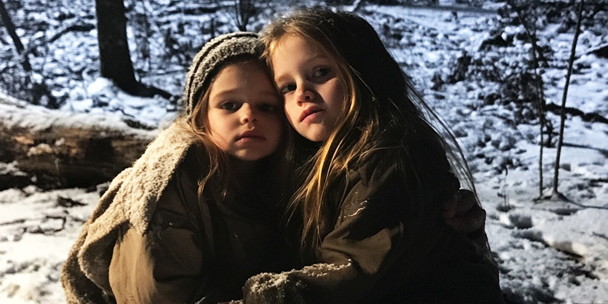Twin girls sitting outside | Source: No source