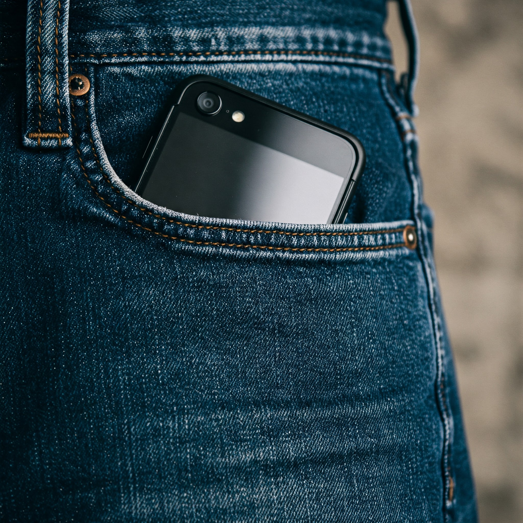 A cell phone in a man's denim jean pocket | Source: No source