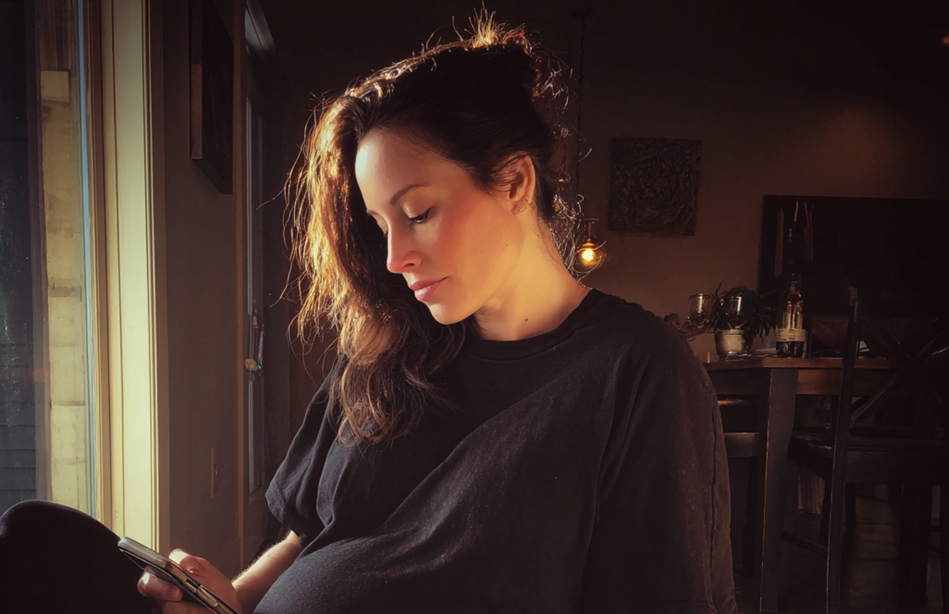 A tired woman using her phone | Source: No source
