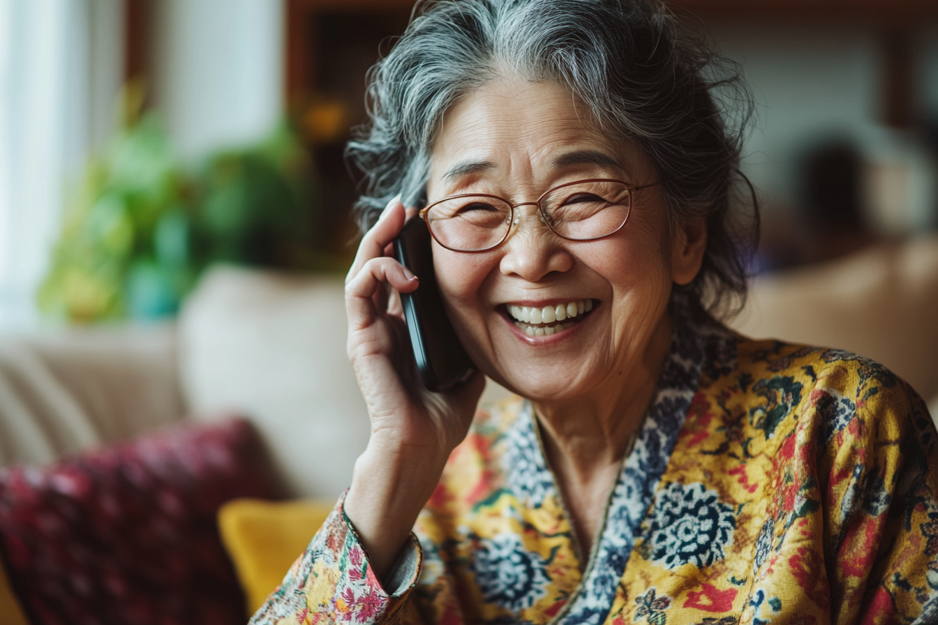 A woman laughing while speaking on her cell phone | Source: No source
