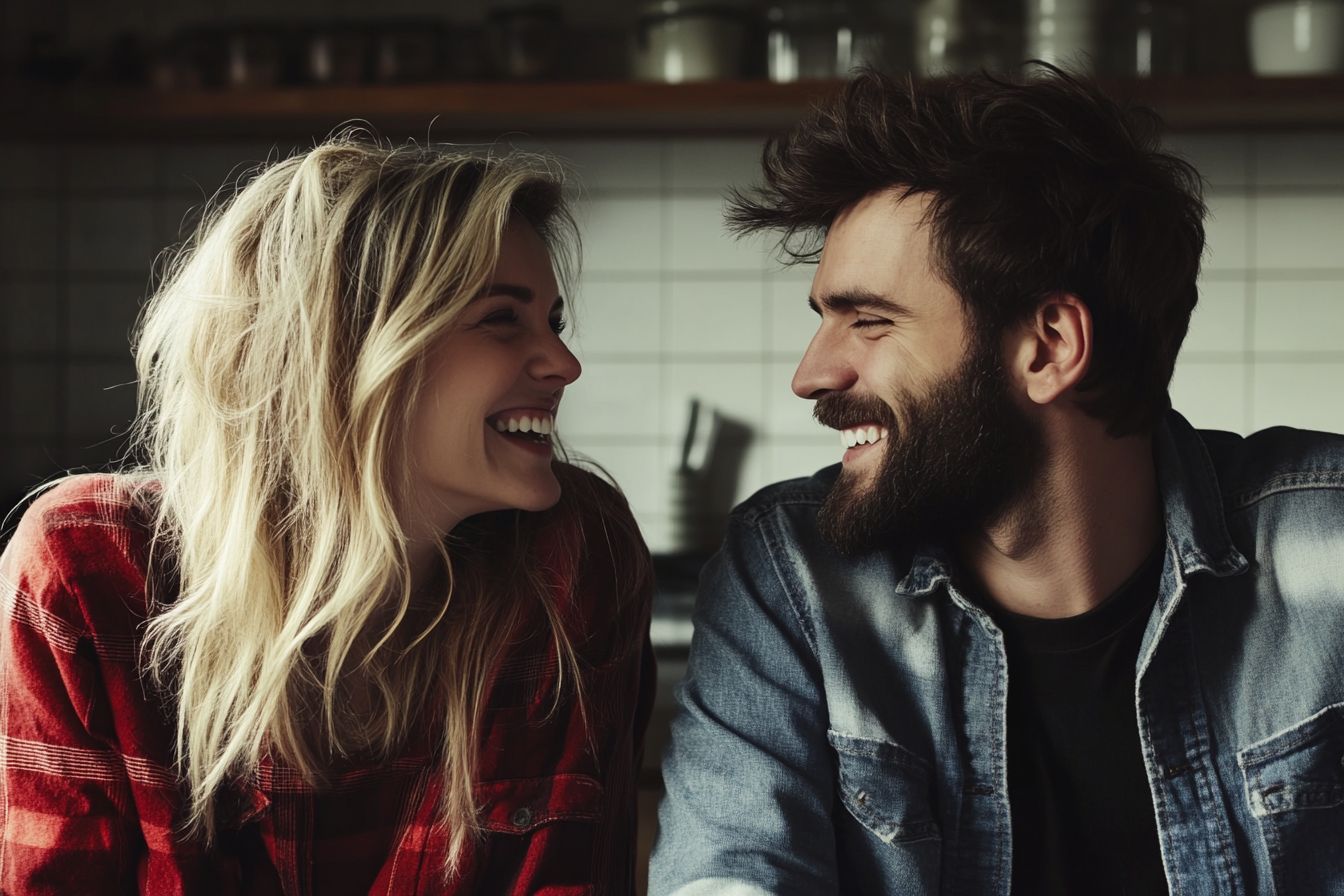 A couple laughing together in a kitchen | Source: No source
