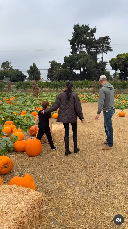 Meghan Markle and Prince Harry walk their son, Archie through a pumpkin patch, as seen in her post dated October 26, 2025 | Source: Instagram/meghan