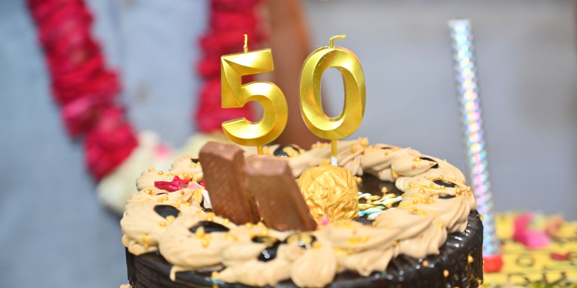 A birthday cake topped with gold number candles marking a 50th birthday celebration | Source: Pexels