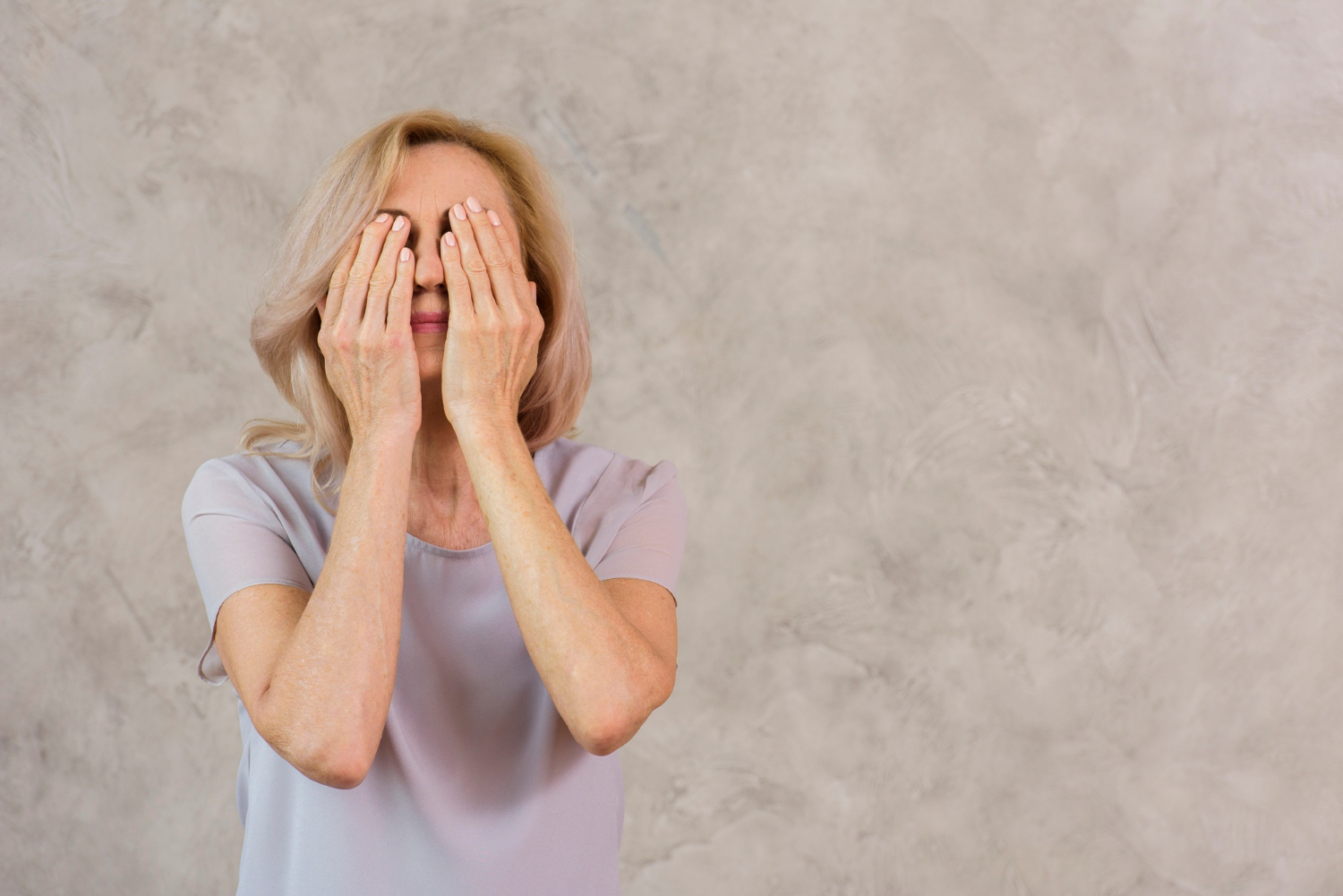 An older woman overwhelmed with sadness | Source: Freepik