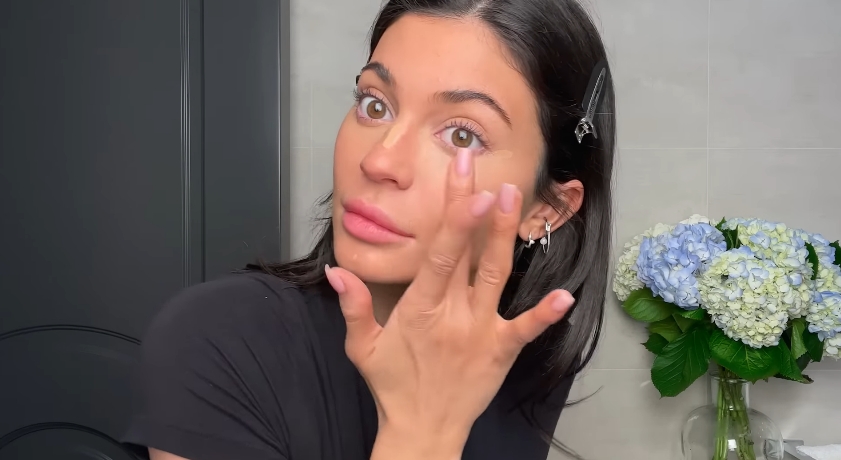 Kylie Jenner doing her classic beauty routine from a video dated April 6, 2023. | Source: YouTube/Vogue