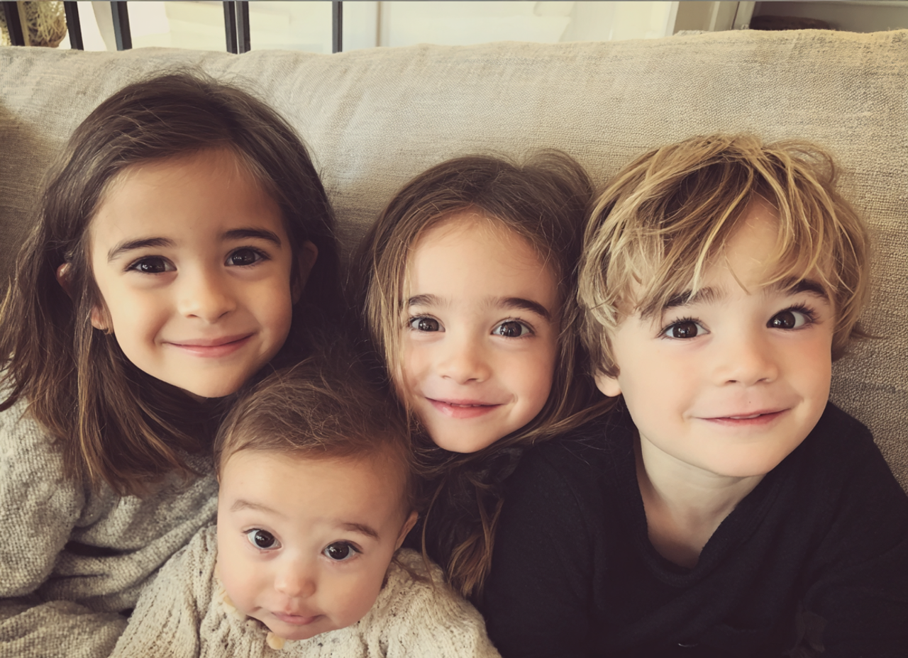 Four young children sitting on a couch | Source: No source