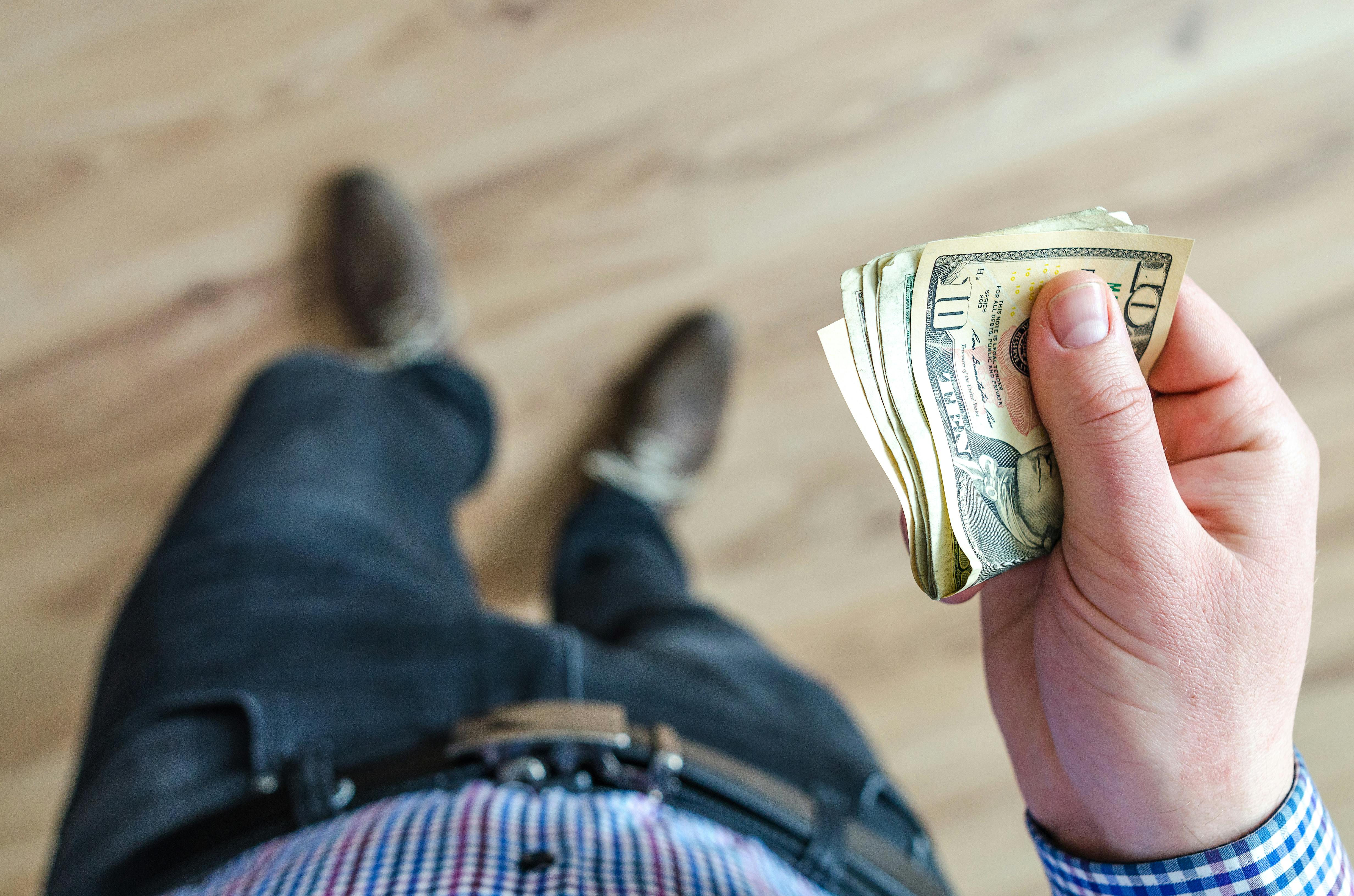 Person holding money | Source: Pexels
