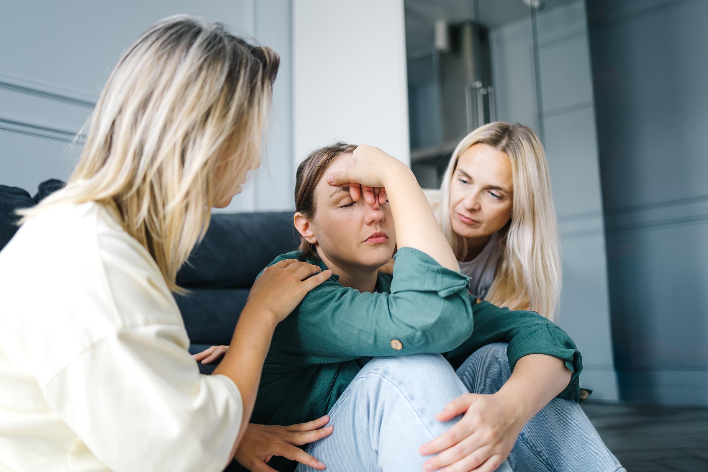 Friends supporting a woman going through depression | Source: Getty Images