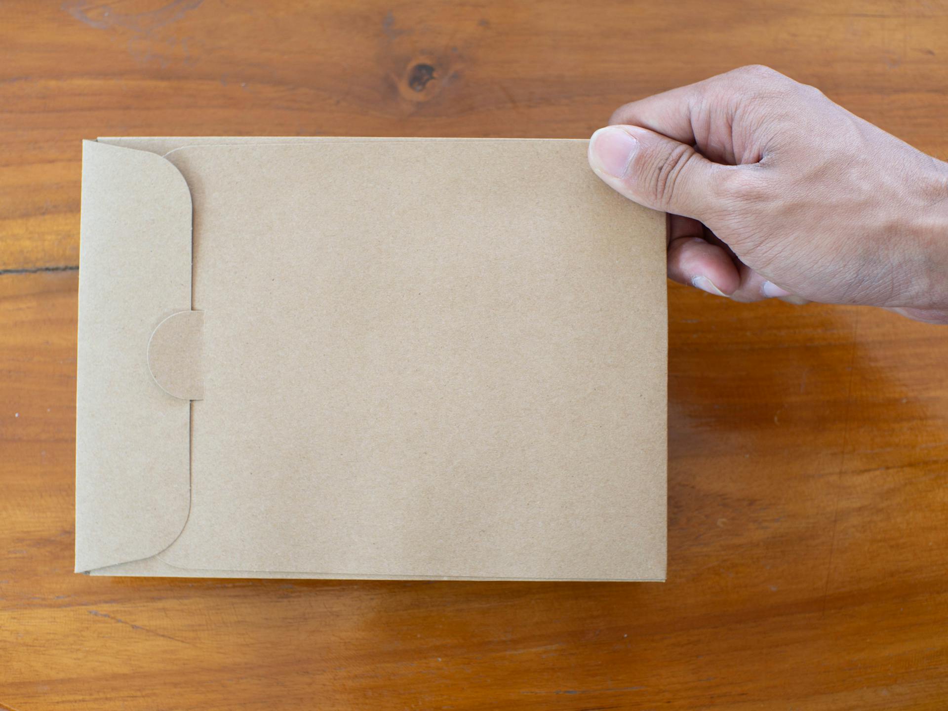 A person holding a manila envelope | Source: Pexels