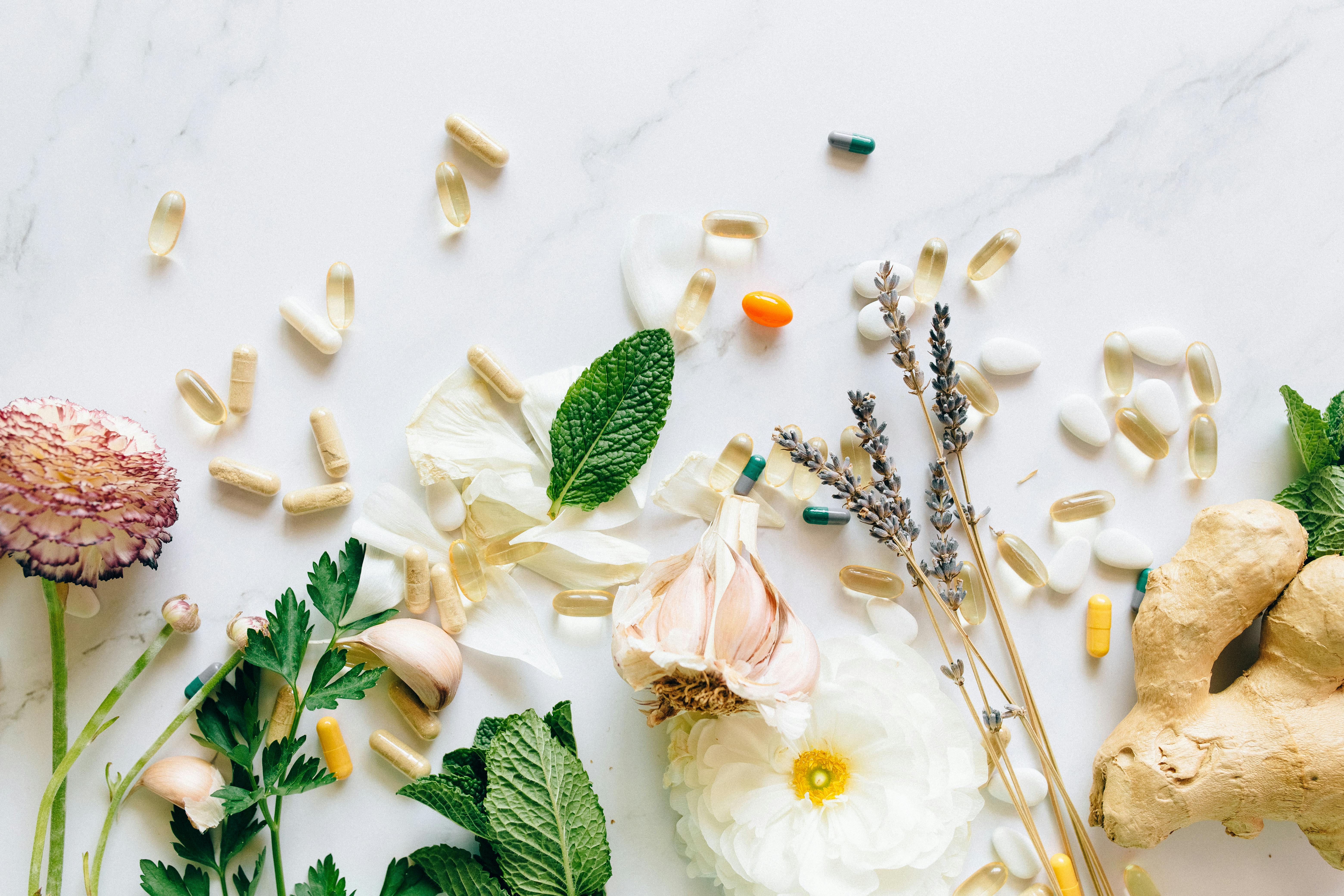 A flat lay of assorted supplements, herbs, and natural ingredients | Source: Pexels